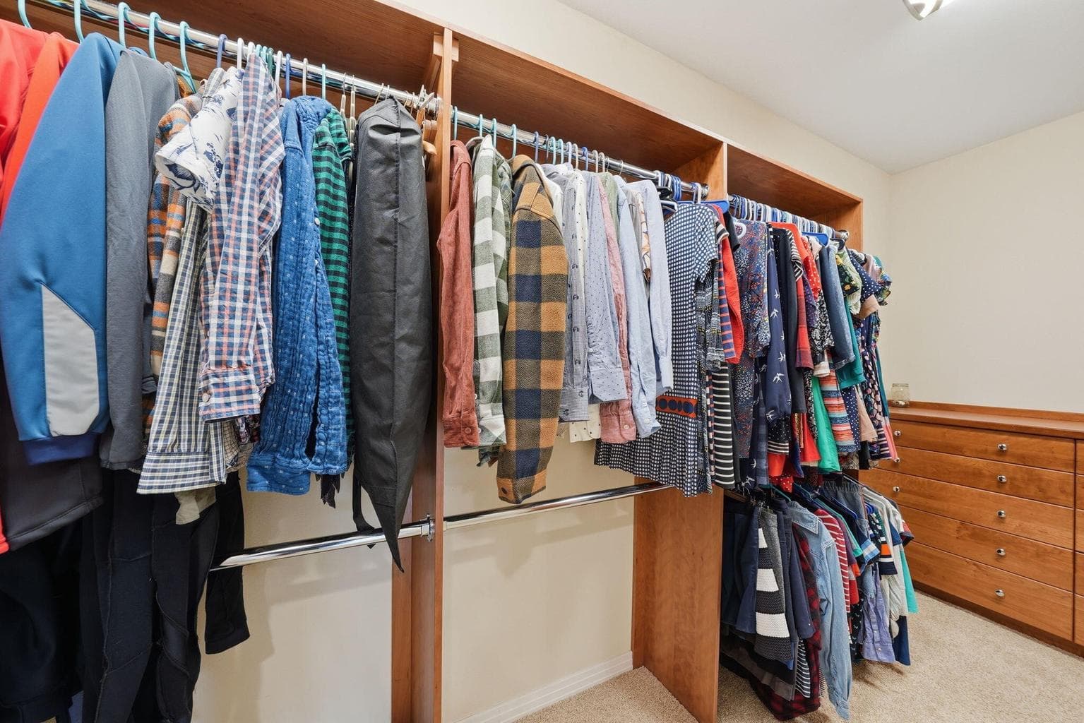 Walk-in closet with custom built-in shelving and dresser