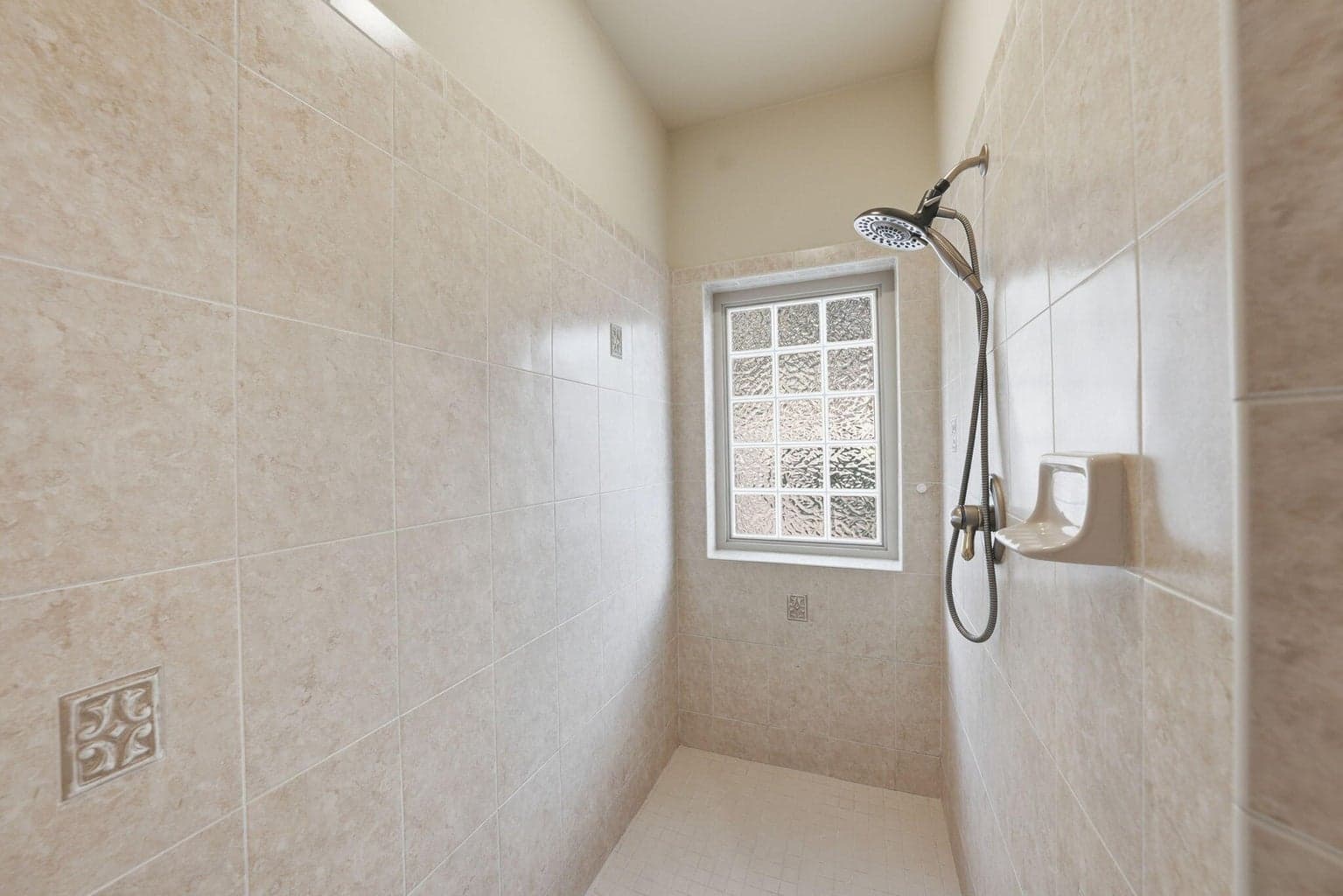 Travertine tiled walk-in shower