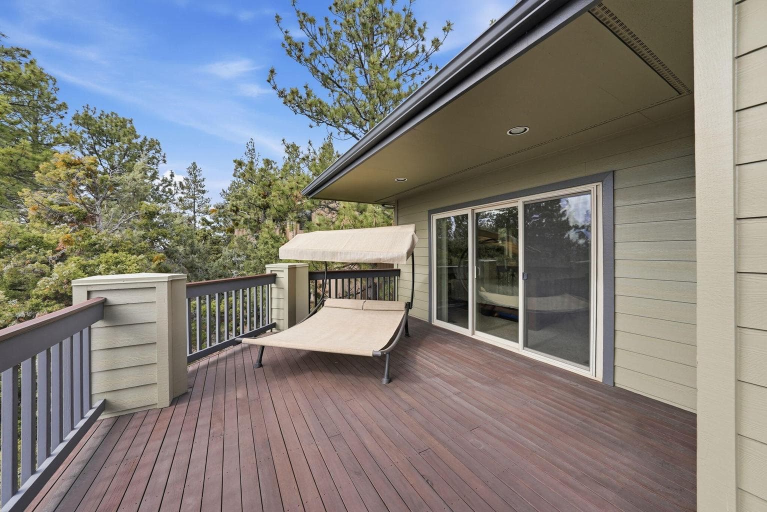 A private deck extends from the Primary Suite, creating a tranquil setting for morning coffee, evening stargazing, or a future hot tub retreat.