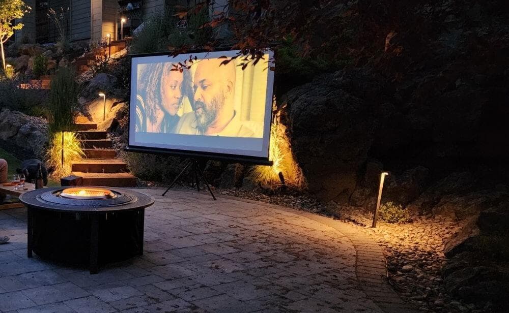 Paver patio custom lighting and wood firepit