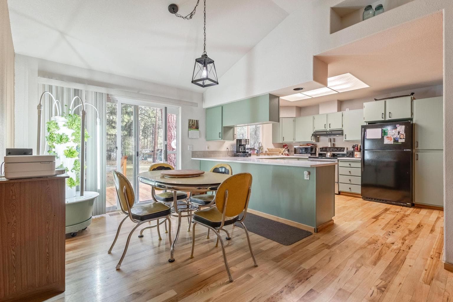 Open kitchen and dining area with hardwood floors.