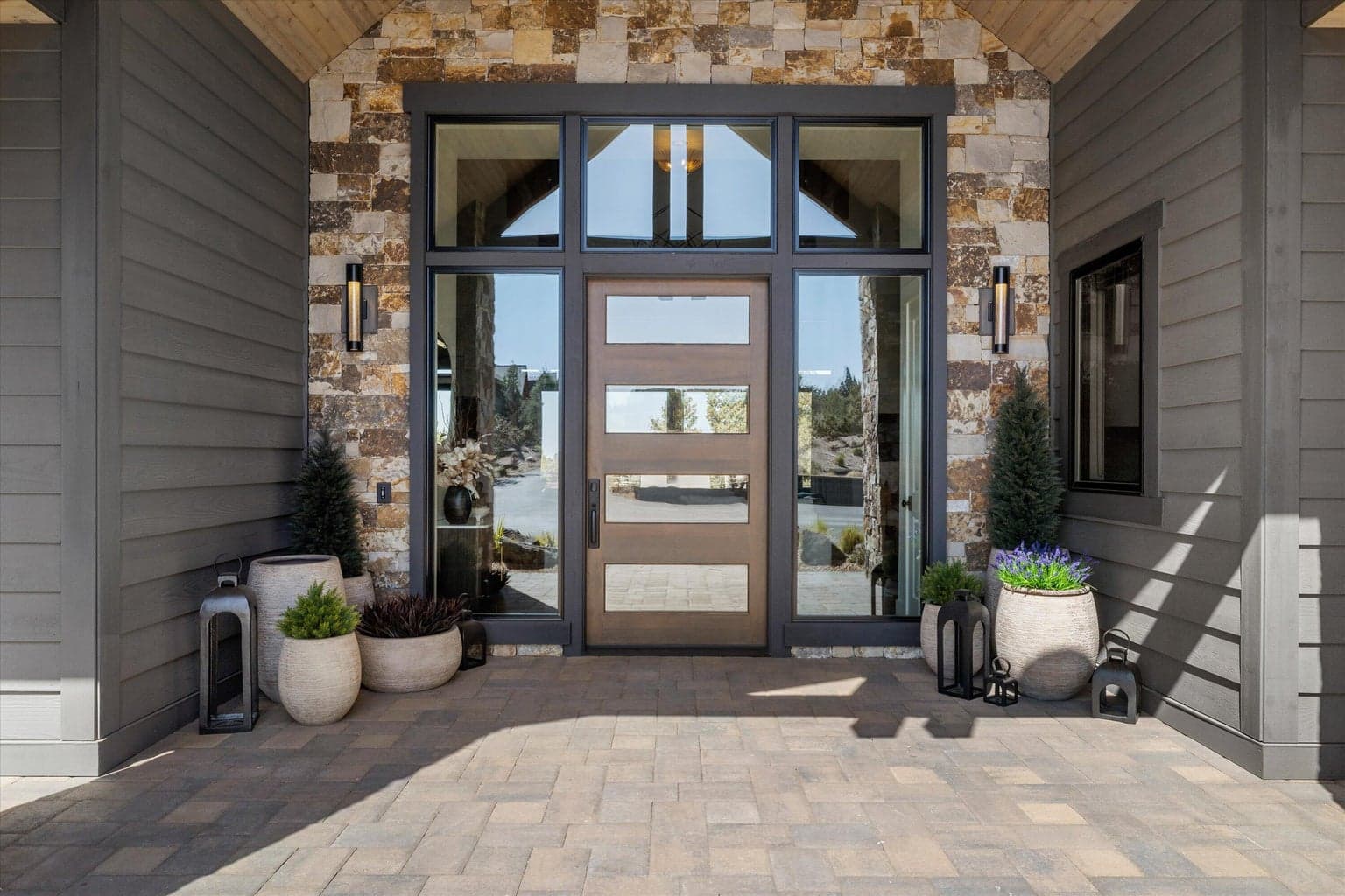 Welcoming covered porch with oversized glass entry