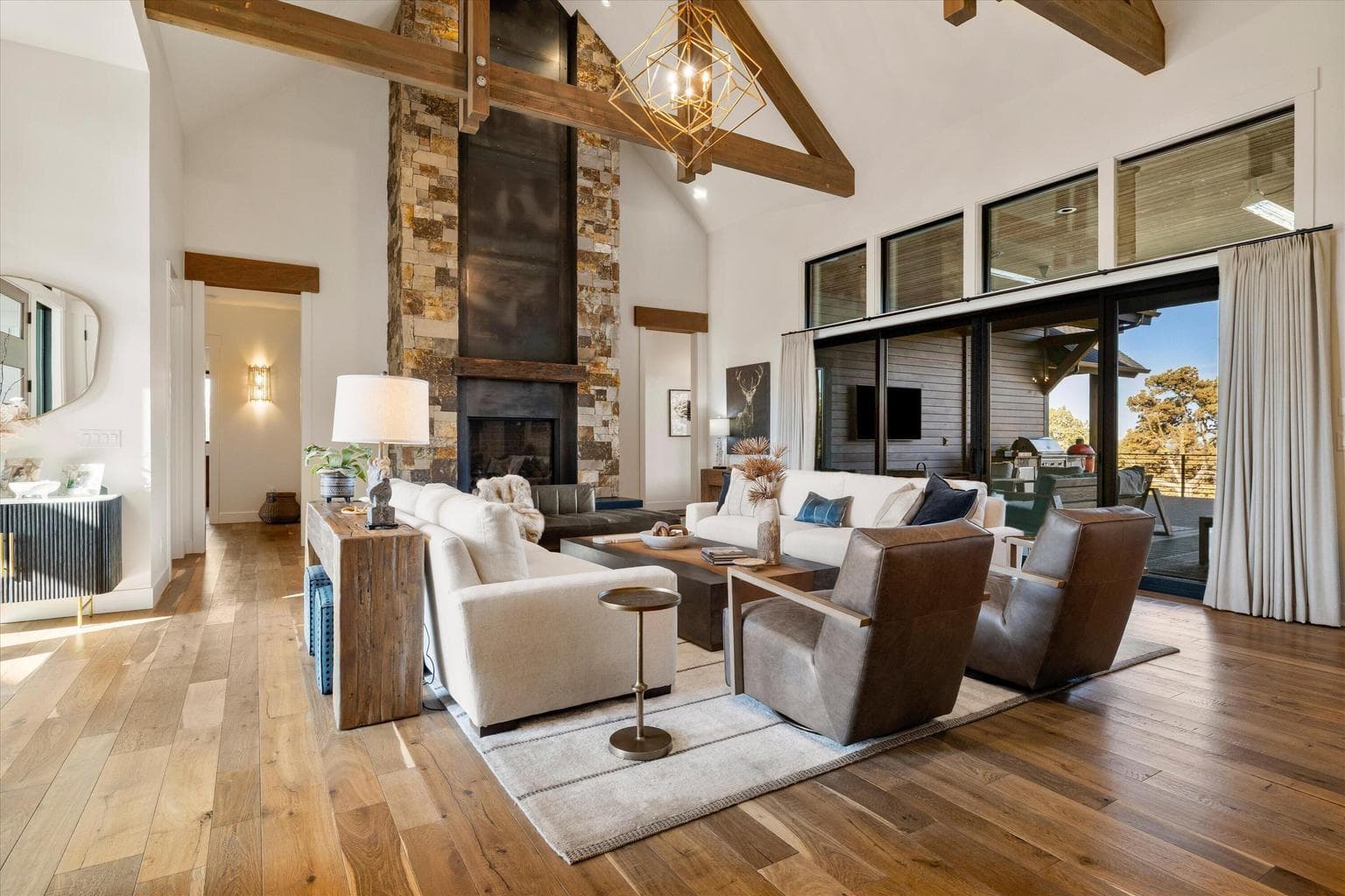 Floor-to-ceiling stone fireplace, sliding doors to oversized patio for easy outdoor-indoor living