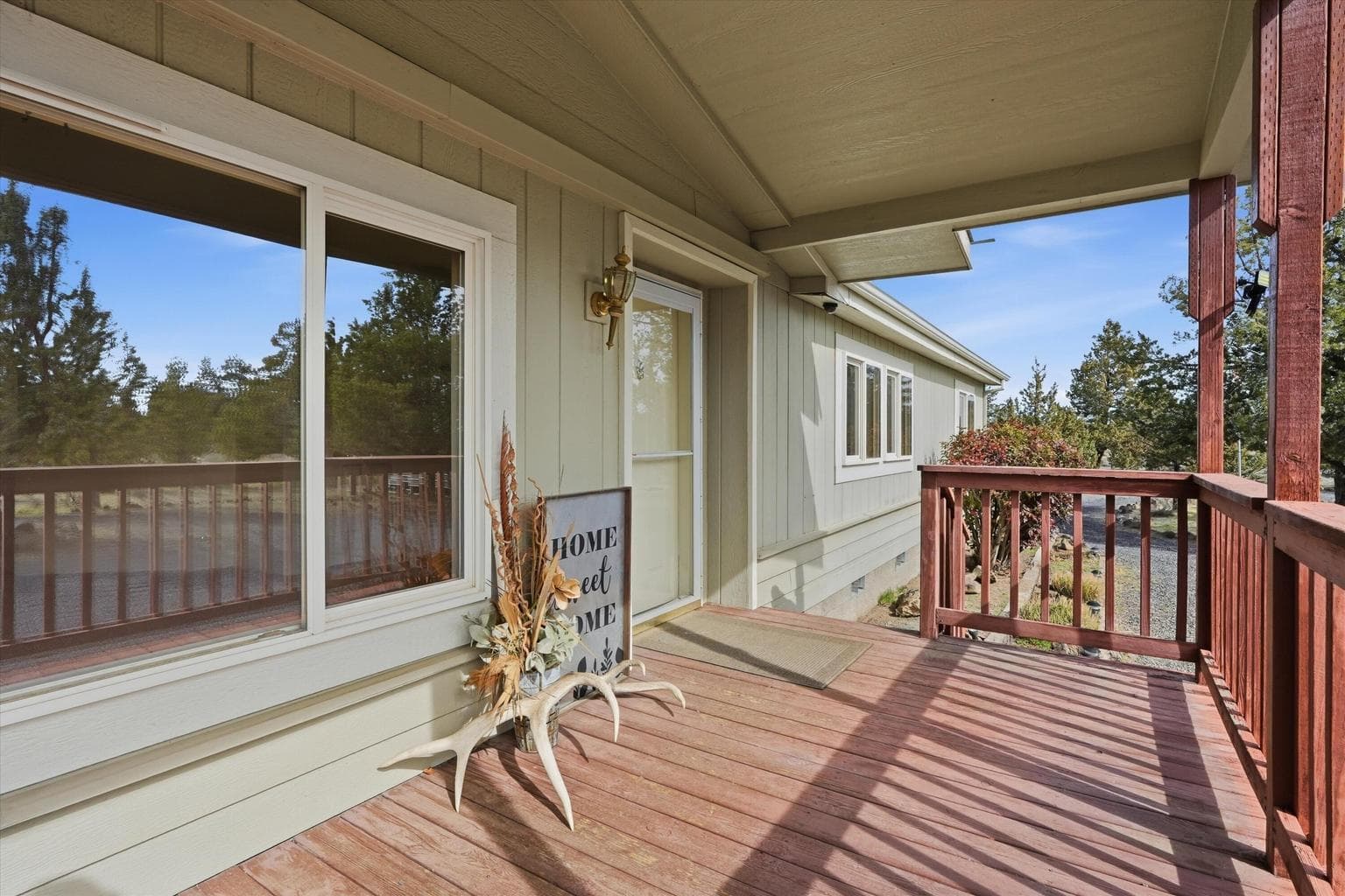 Covered patio and front door with screen door