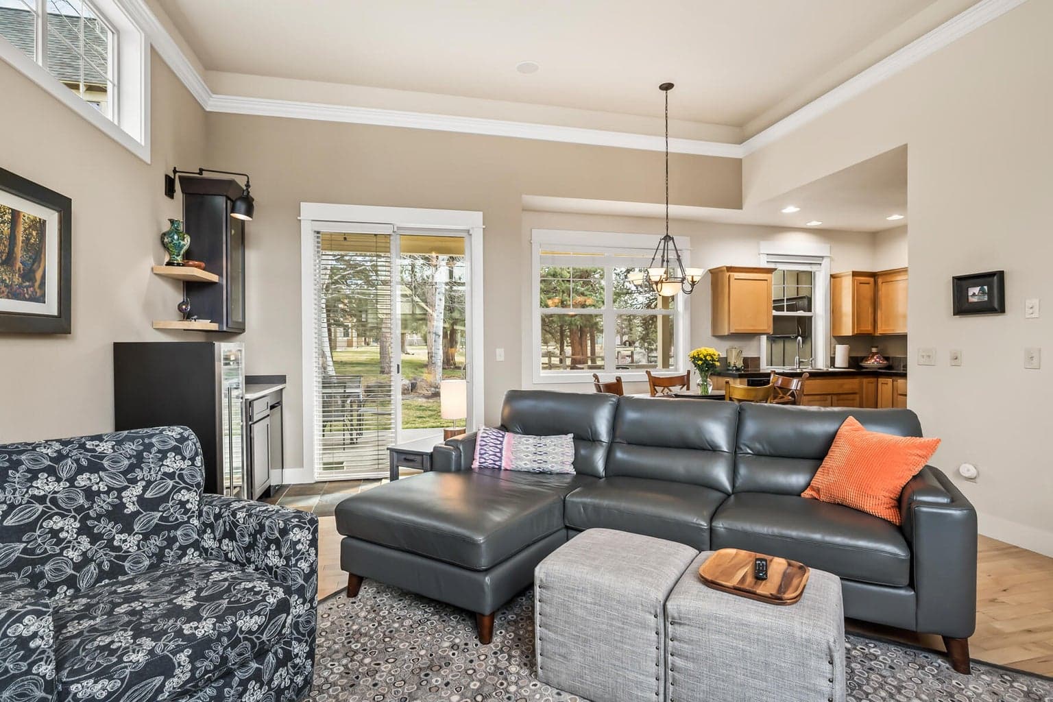 Light filled living area with serene views into the green space behind the home