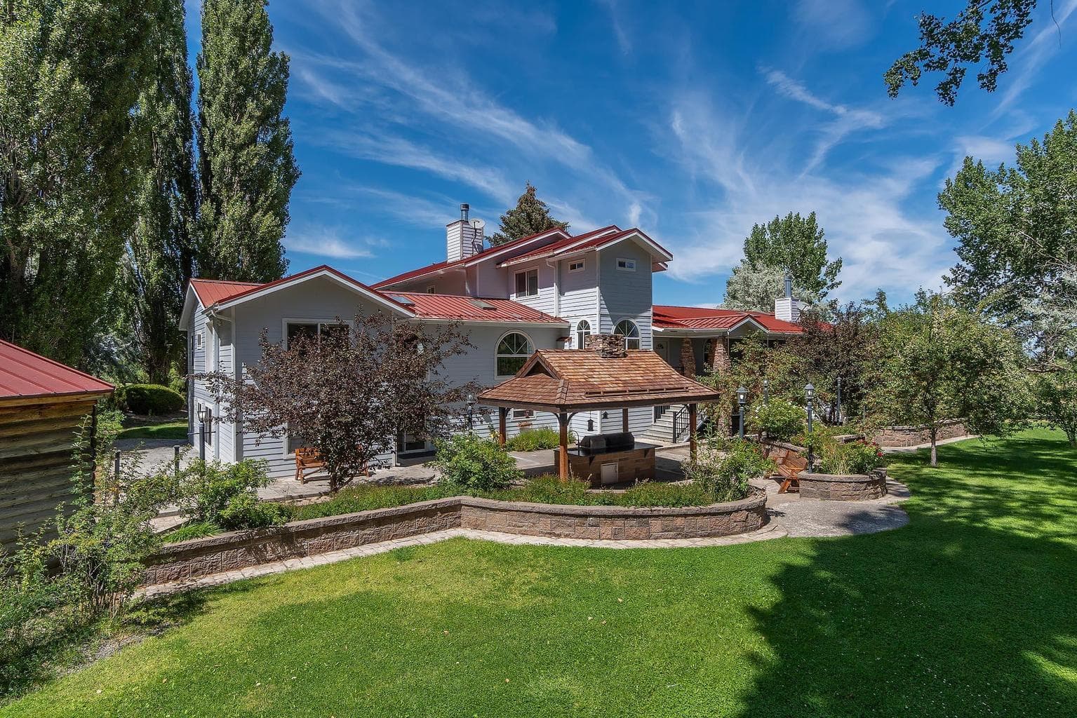 Beautiful back yard view with patio and outdoor kitchen