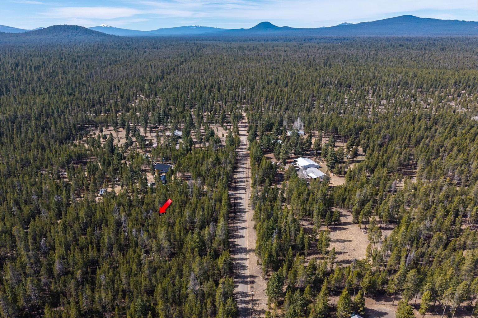 Wide aerial view highlighting the property's proximity to the Deschutes National Forest and nearby recreation.