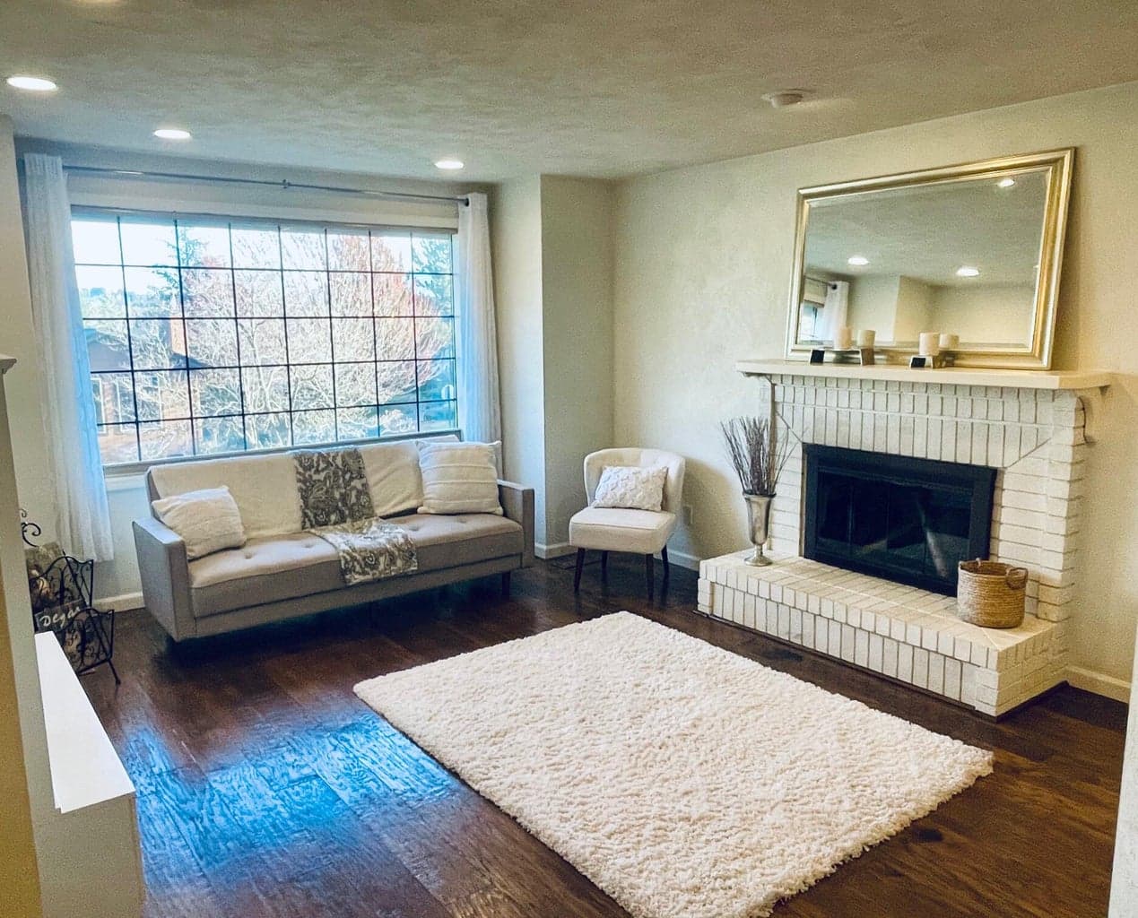 Front living room with wood-burning fireplace.