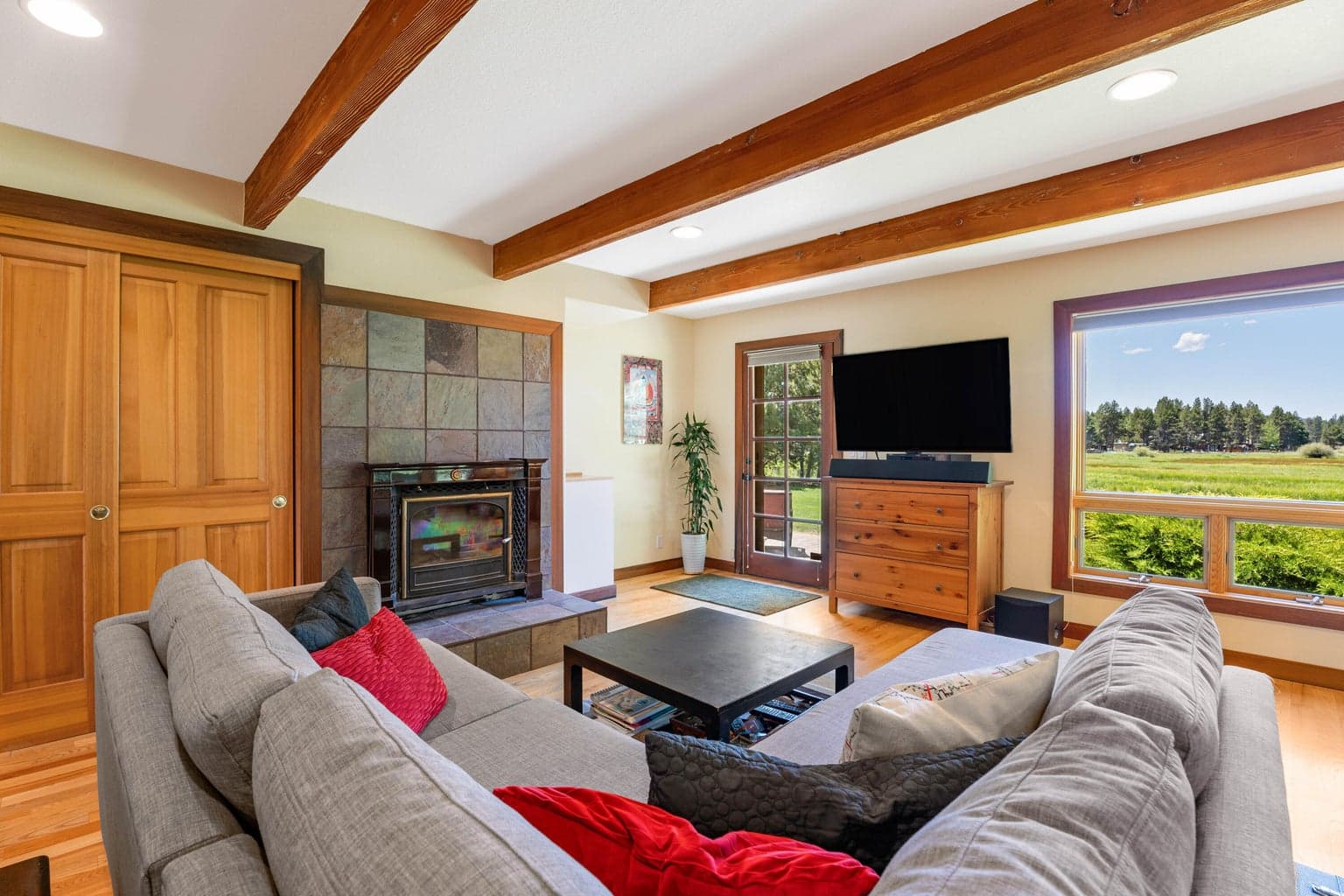 Sitting area in main primary with wood burning stove, stunning views and door to the outside patio & hot tub.