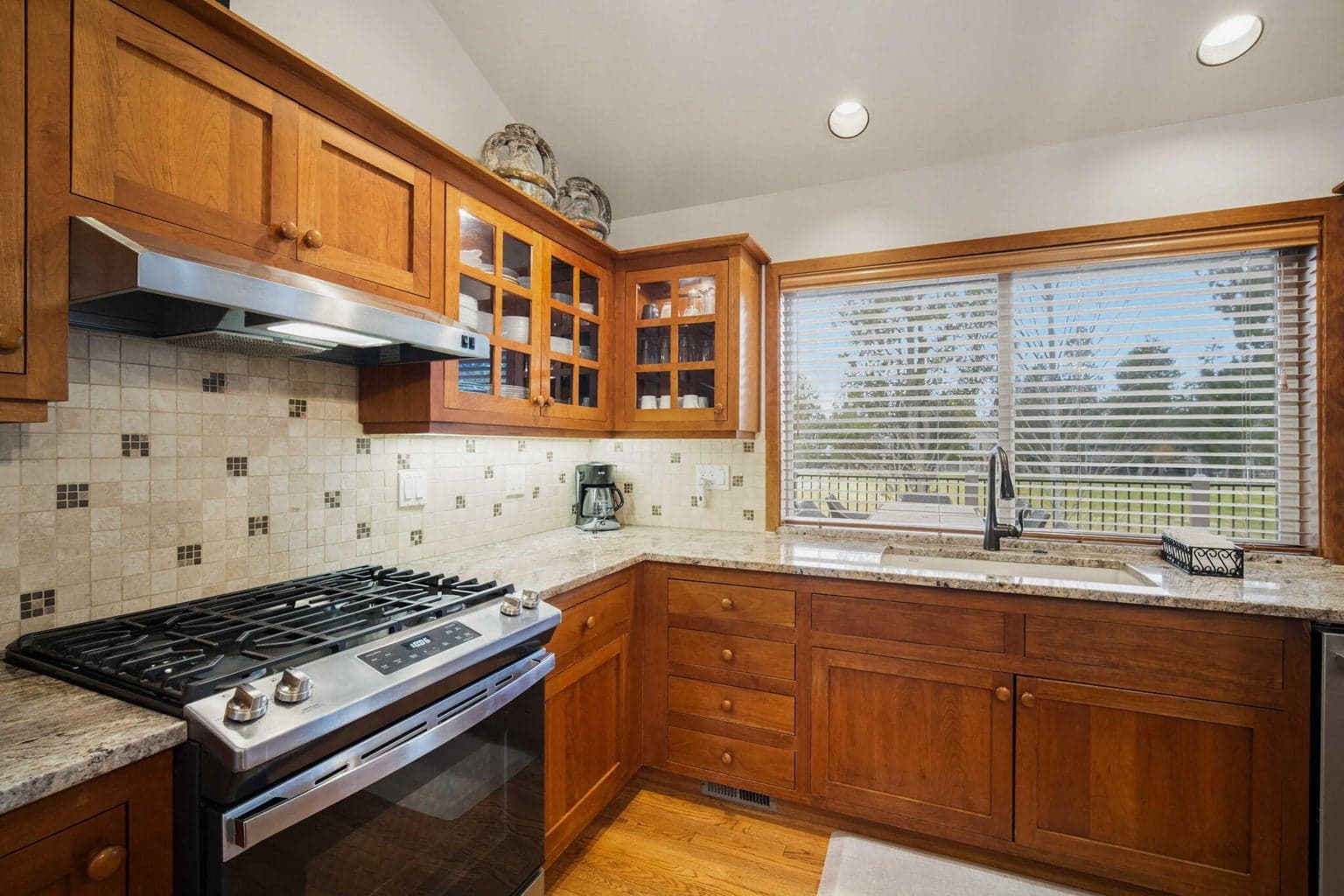 The kitchen is equipped w/ granite countertops, double ovens & stainless appliances.