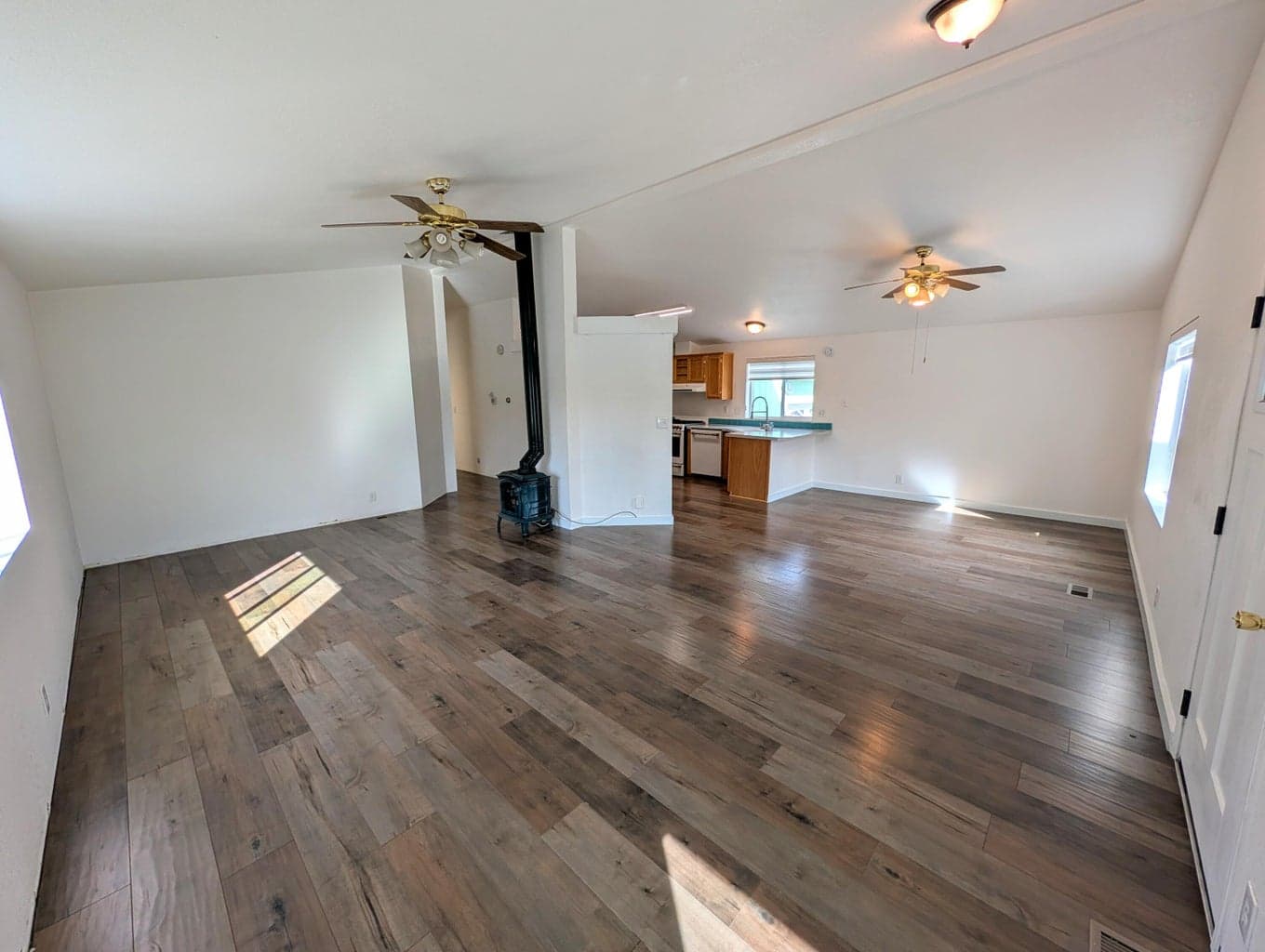 Large open living area with newer floors.