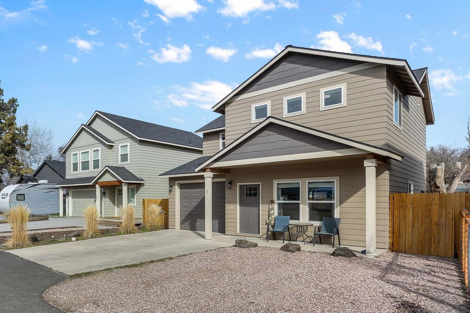 A wider view showing the full front of the property and the surrounding street.