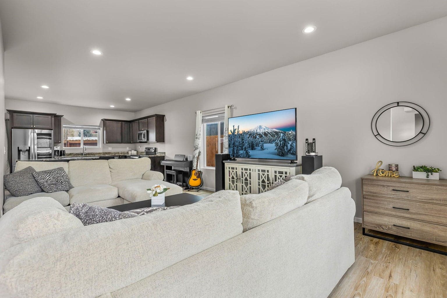 A perspective of the main living area showing the seamless flow between the kitchen, dining, and living room.