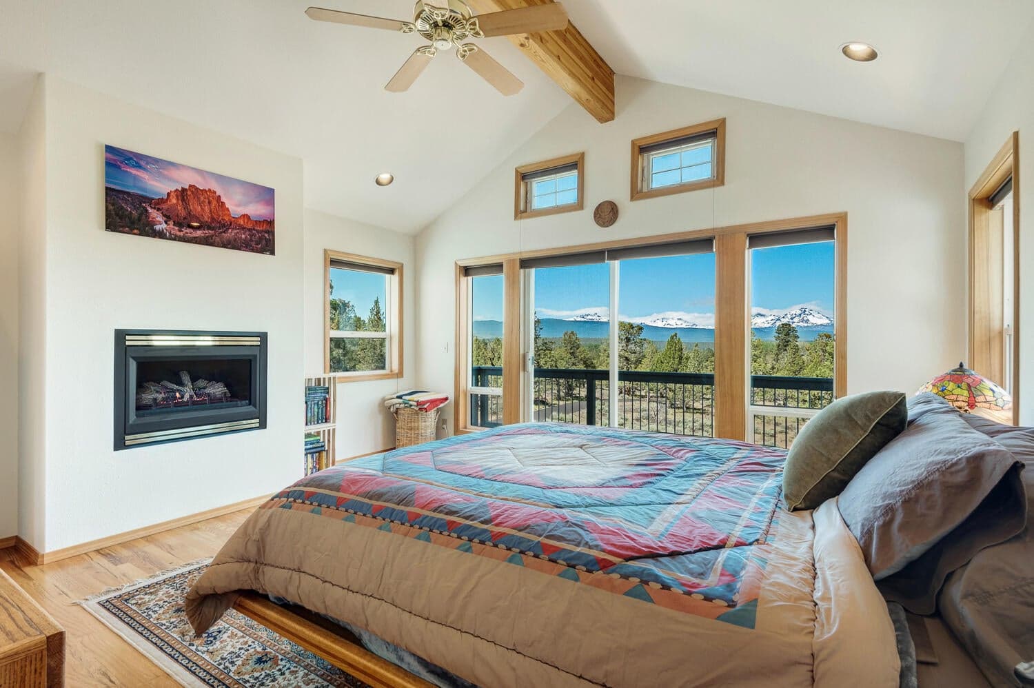 Primary bedroom w/vaulted ceilings and propane fireplace