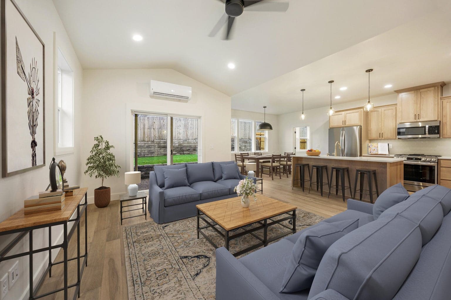 Open living, kitchen, dining area, virtually staged