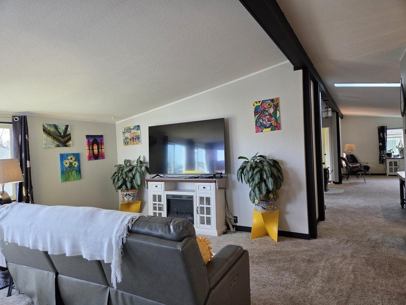 Living room is large has beam, lots of windows, living room and primary suite are separate from other rooms, making it really nice when guests visit.