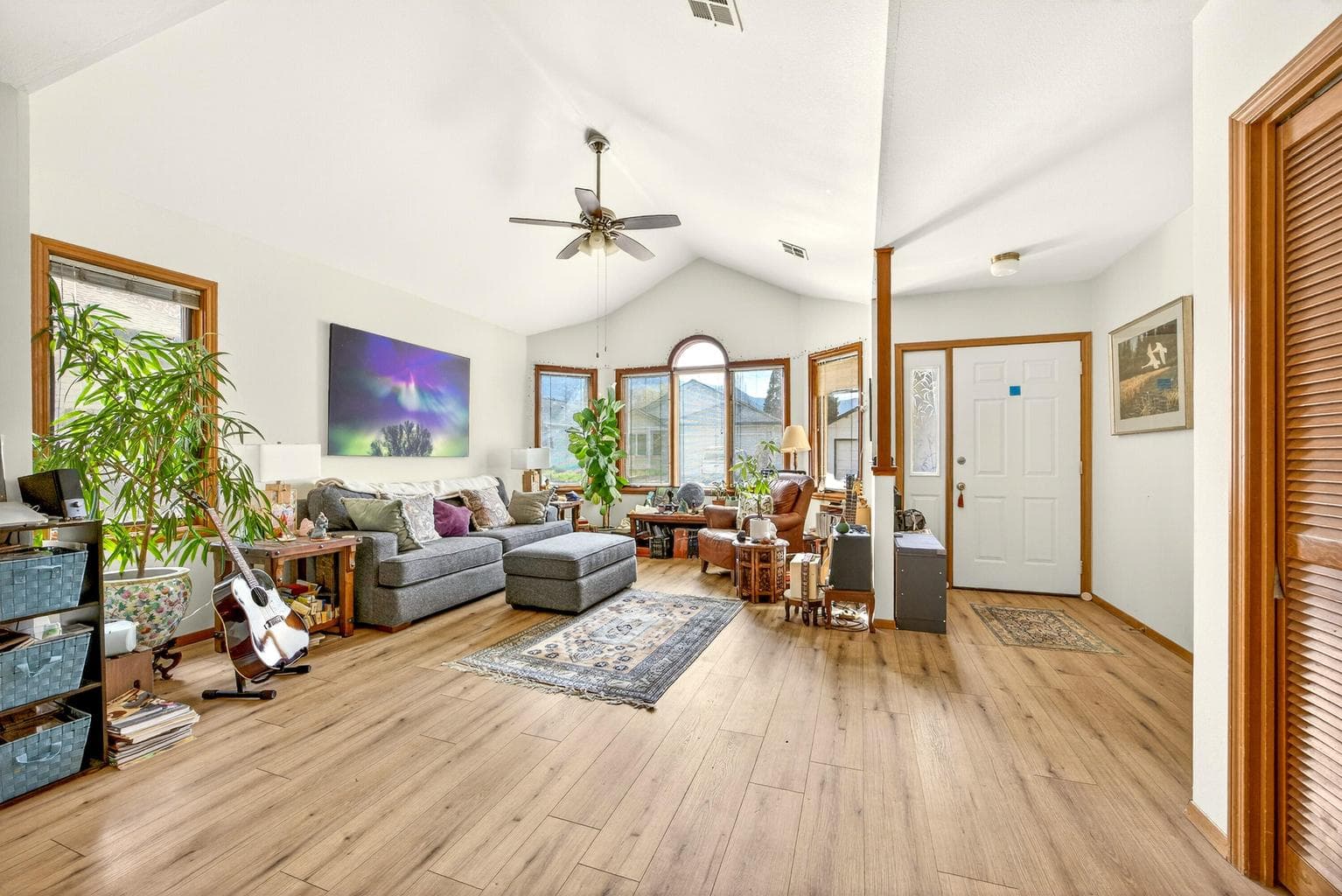 Living room with vaulted ceiling and ceiling fan