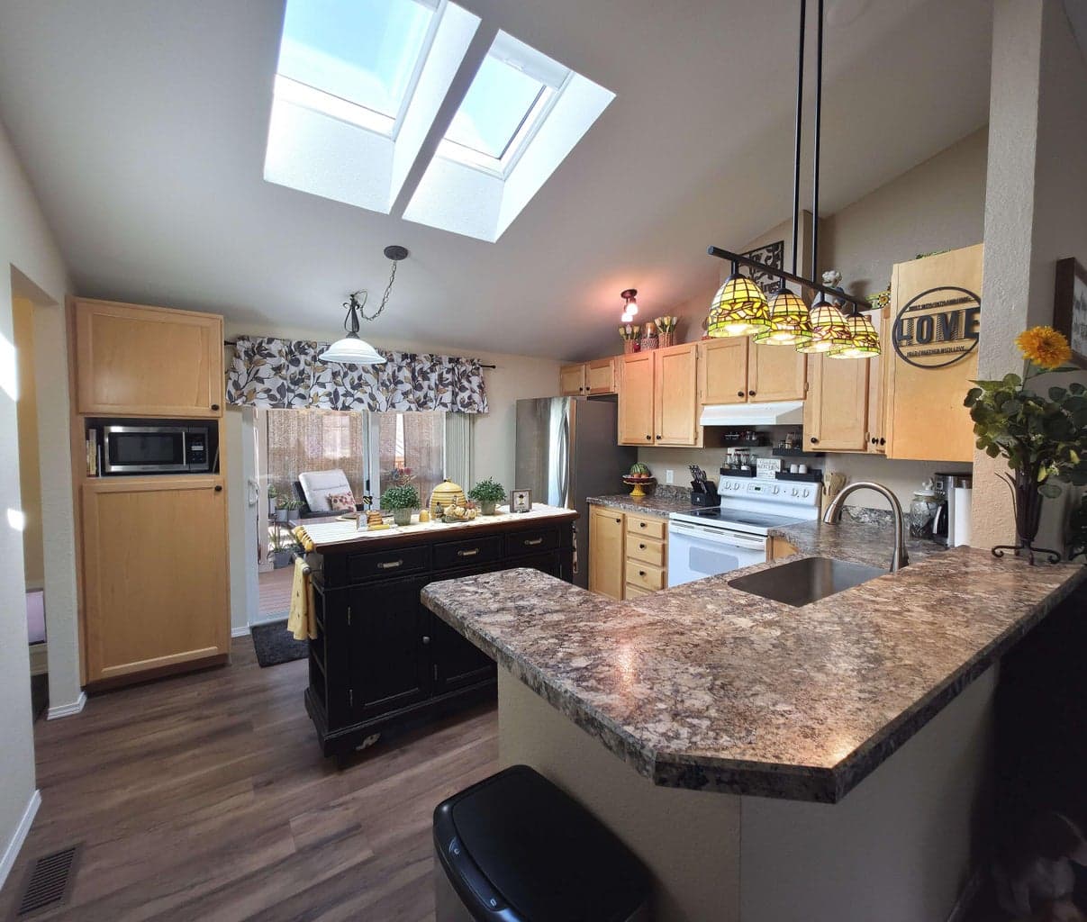 Kitchen has new sliding glass doors and skylight