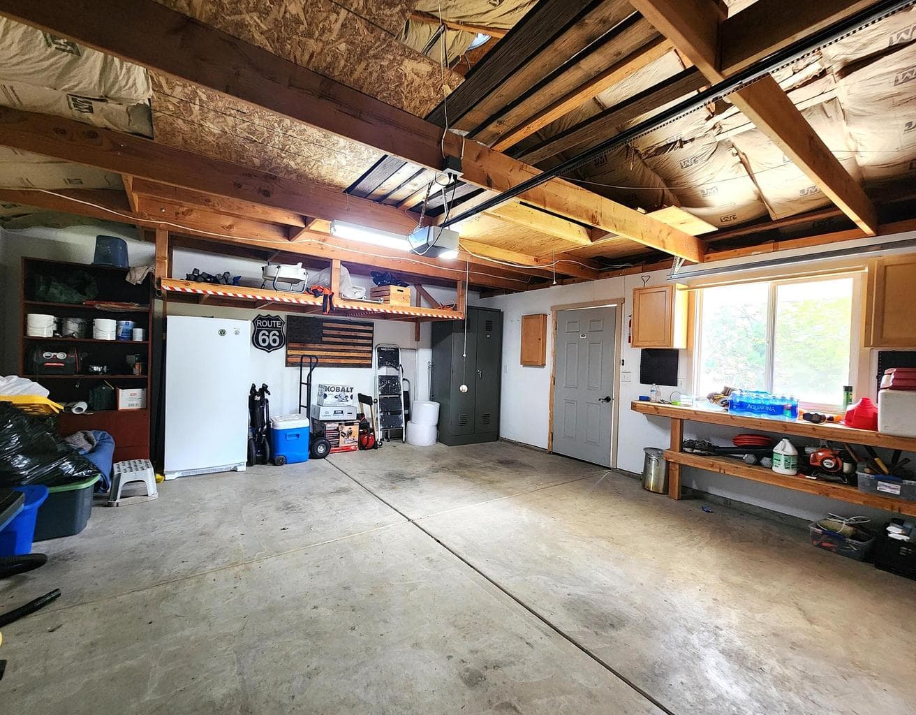 Garage has room for a work bench and storage