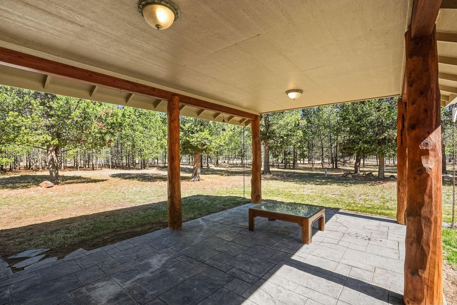 Covered stamped concrete back porch located off great room