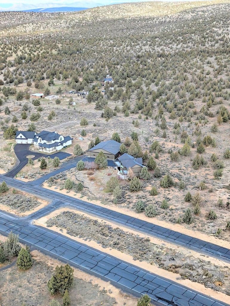 Bird’s-eye view highlights the property layout, surrounding area, and the privacy and space this home has to offer.