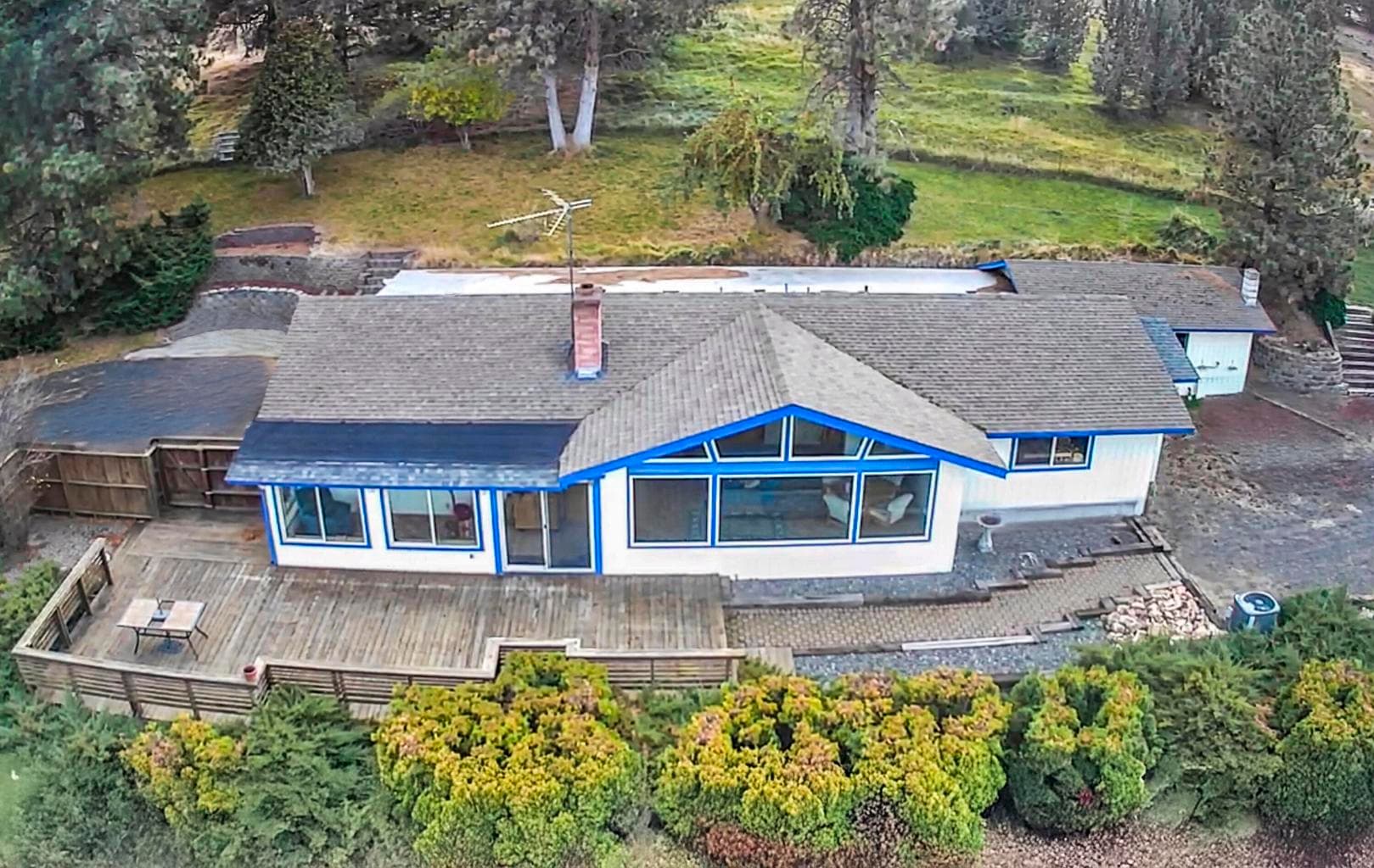 Aerial view of the home, showing the fenced pasture above