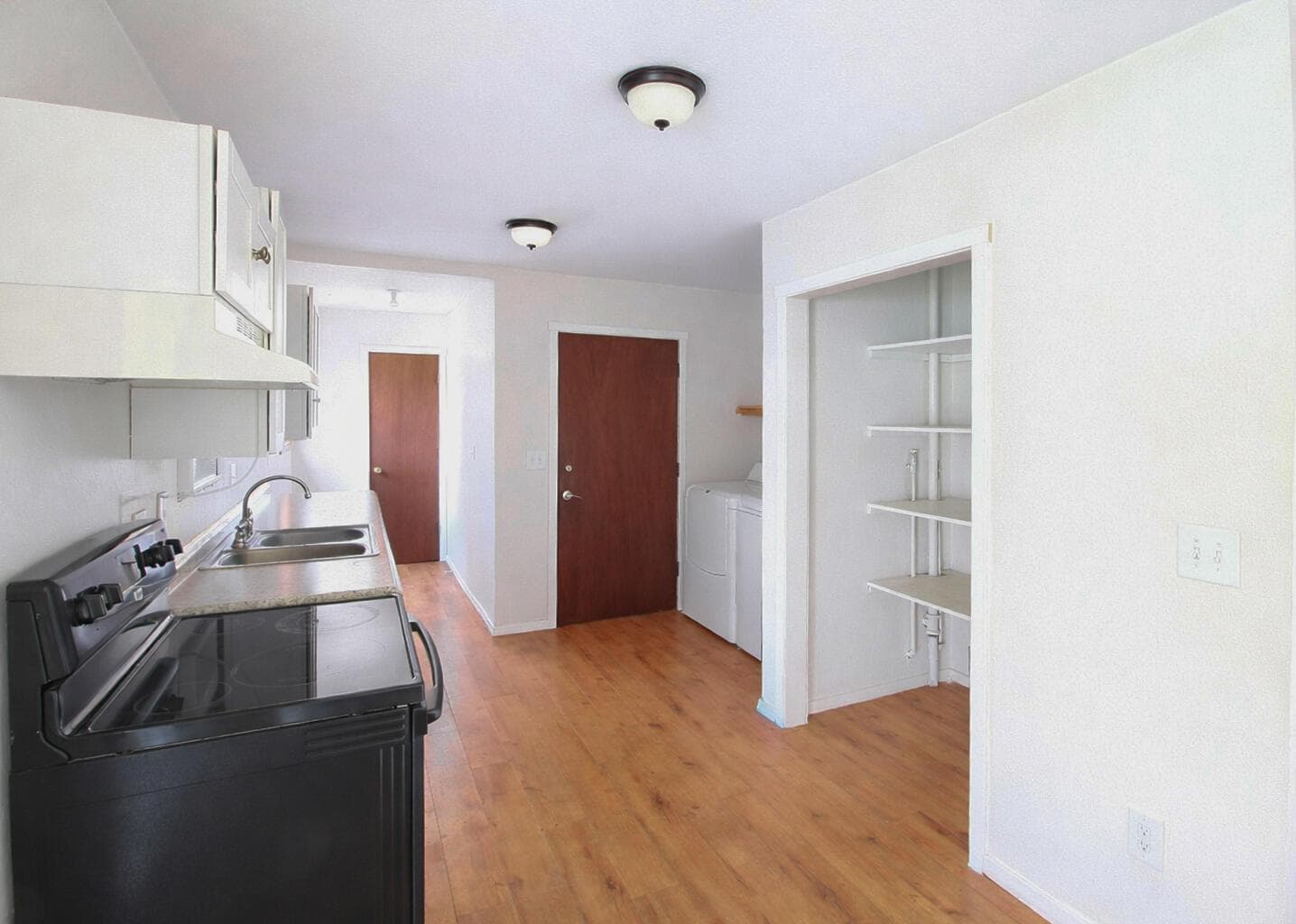 Door on other side of sink and counter is a pantry, door to the right enters into garage