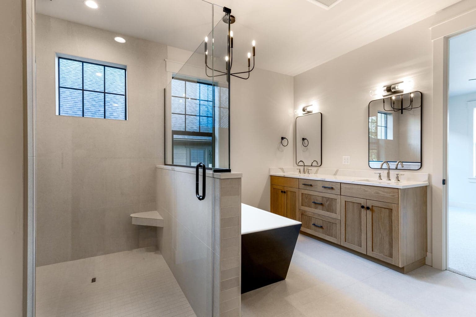 Primary bathroom with heated tile floors, dual shower head and stand alone tub
