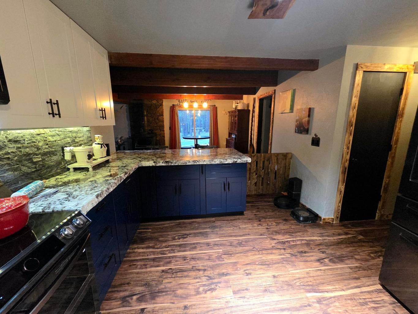 view looks toward the dining and breakfas bar area. Two pantries in the hallway (door shows 1 of the 2 doors.)
