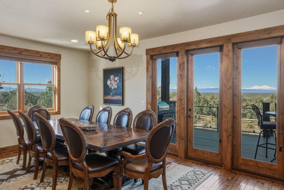 The dining room connects the great room and kitchen, with beautiful custom wood and glass doors leading to the covered, raised deck