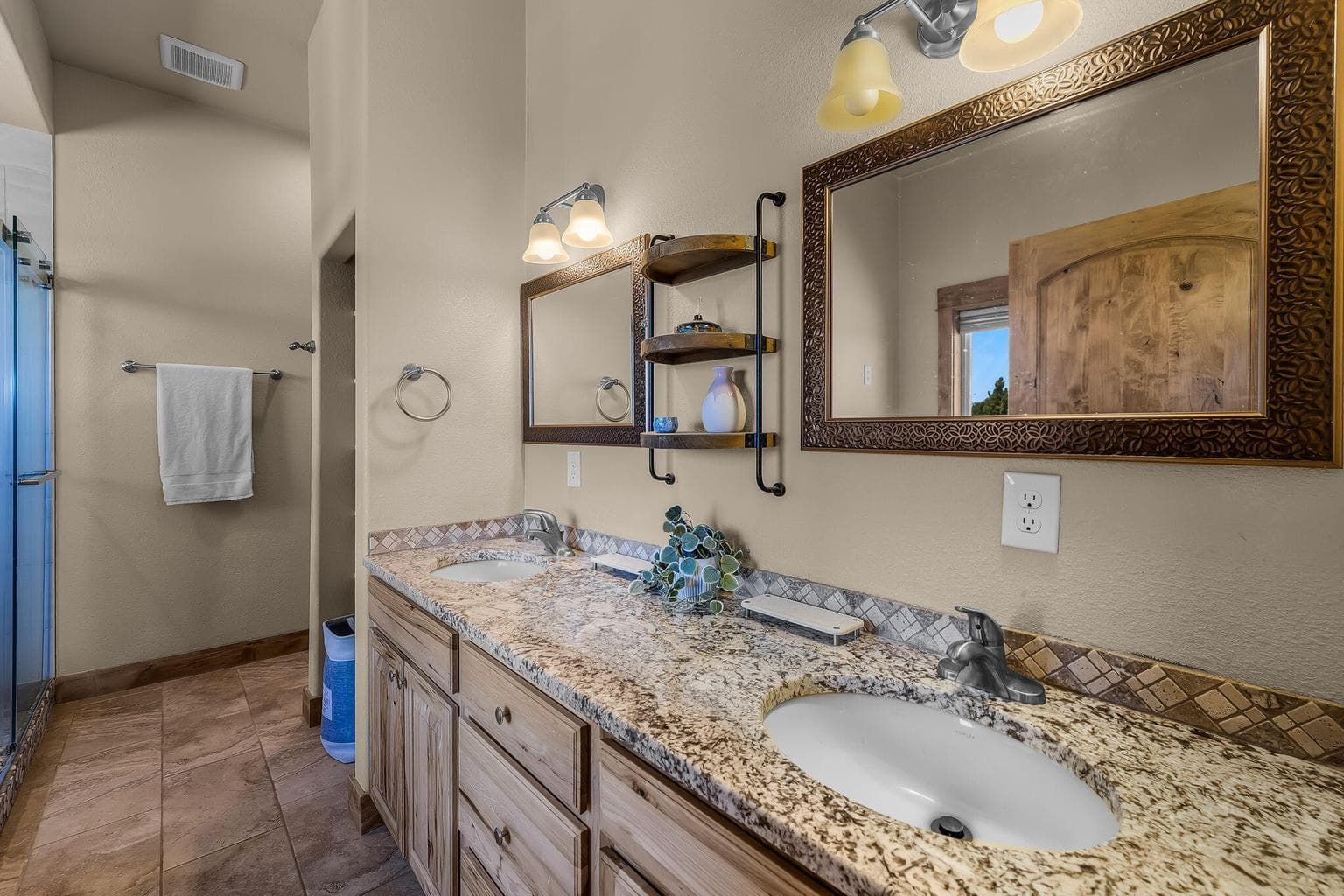 Primary bathroom offers dual vanity, deep soaking tub and spa-like shower