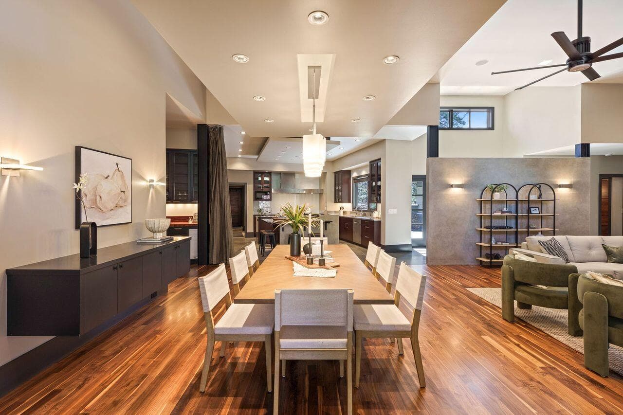 Dining area with direct connection to the kitchen, highlighted by warm walnut flooring, modern lighting, and a layout designed for both everyday living and easy entertaining.