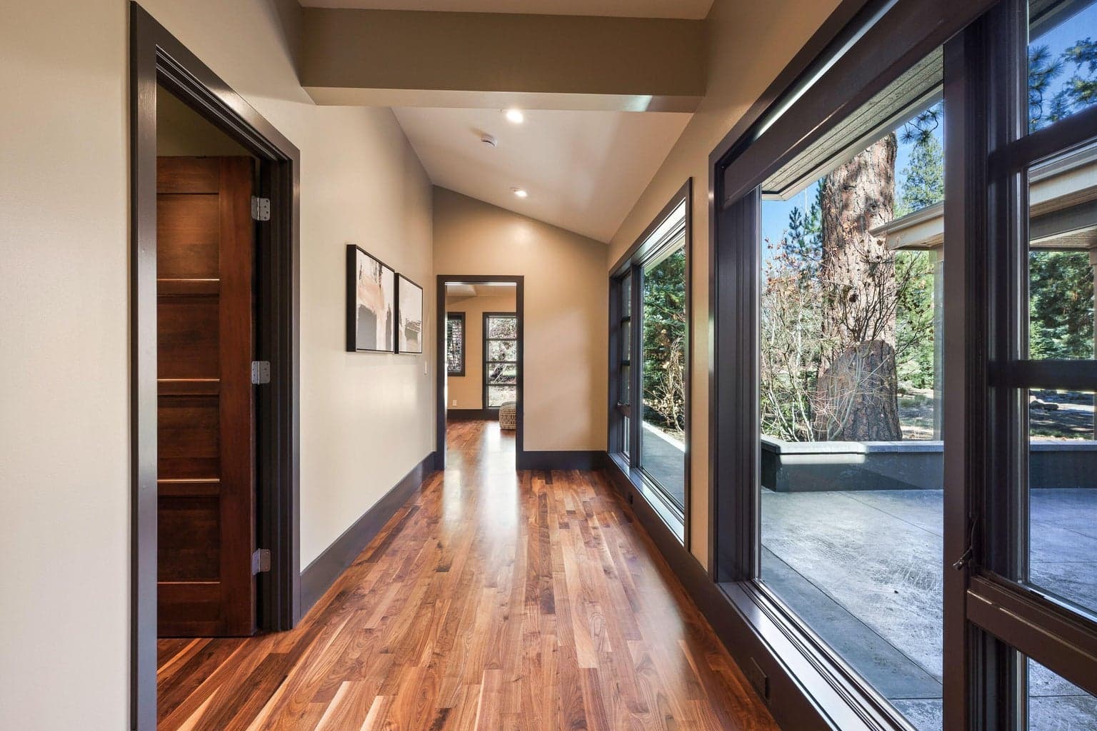 A light-filled hallway/sitting area leads to the private primary suite, creating a peaceful transition from the main living spaces.