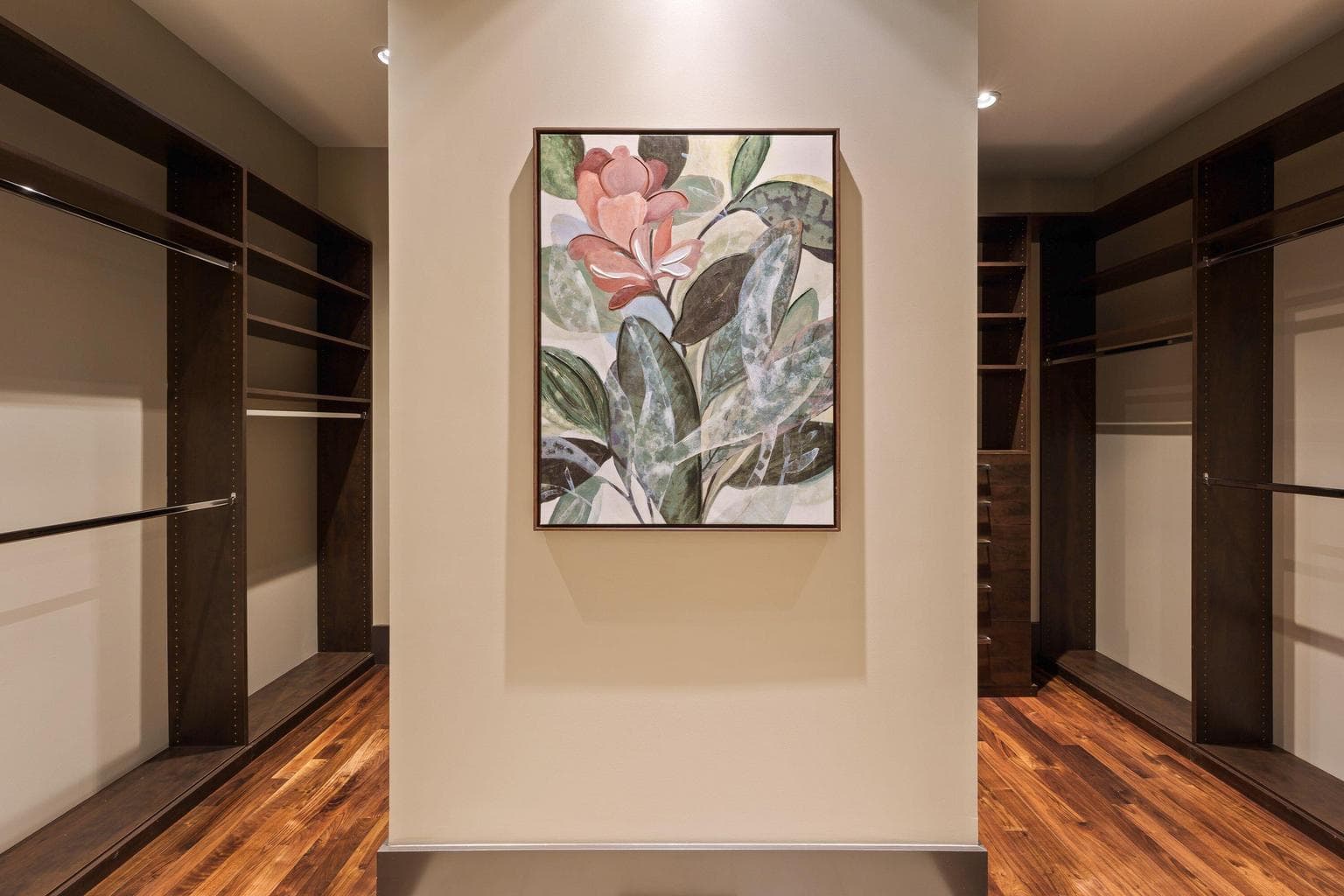 Dual walk-in closets with custom built-ins, offering generous storage and thoughtful organization.