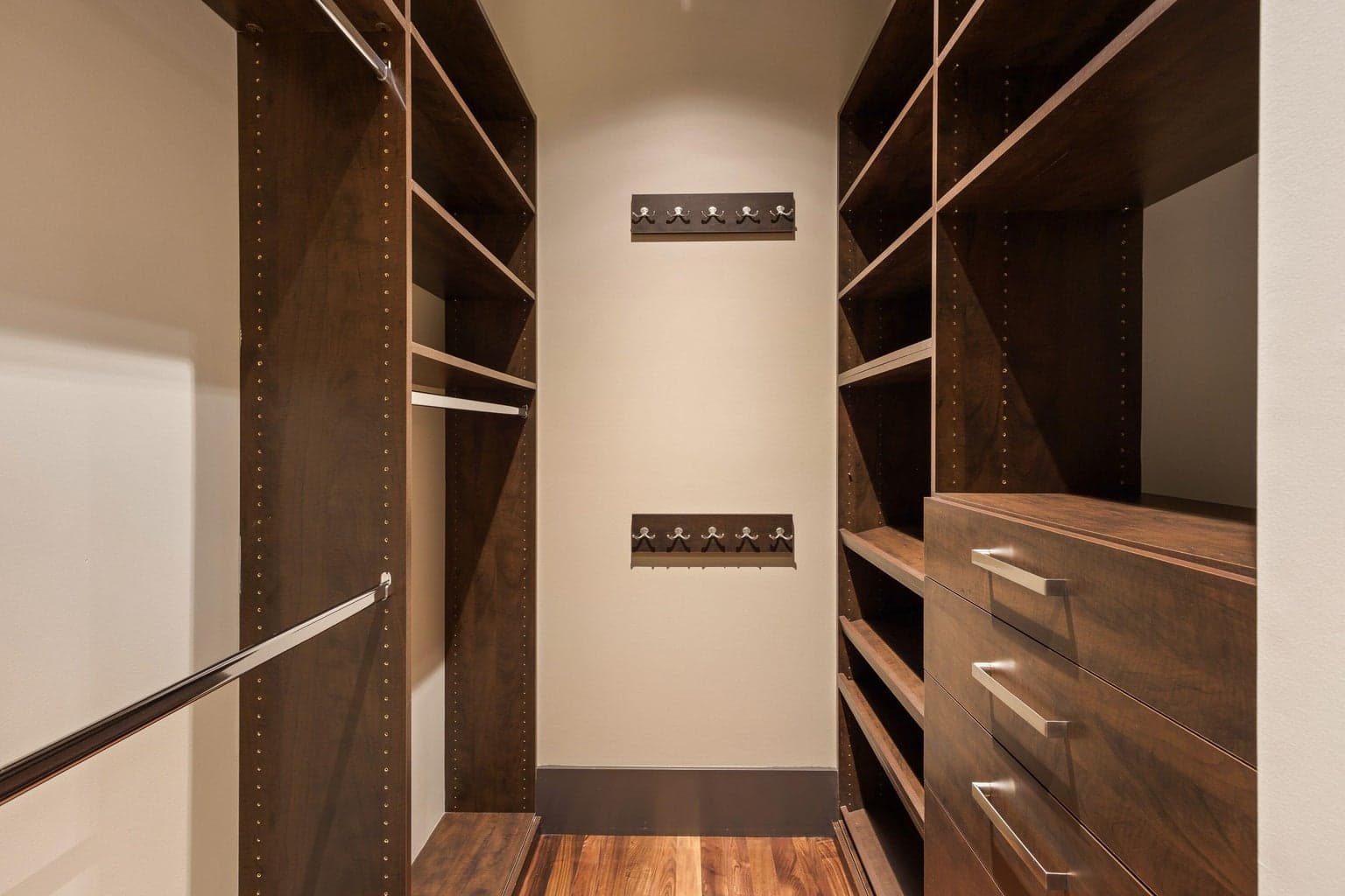 Second walk-in closet with custom built-ins, shelving, and drawers for added storage and organization.