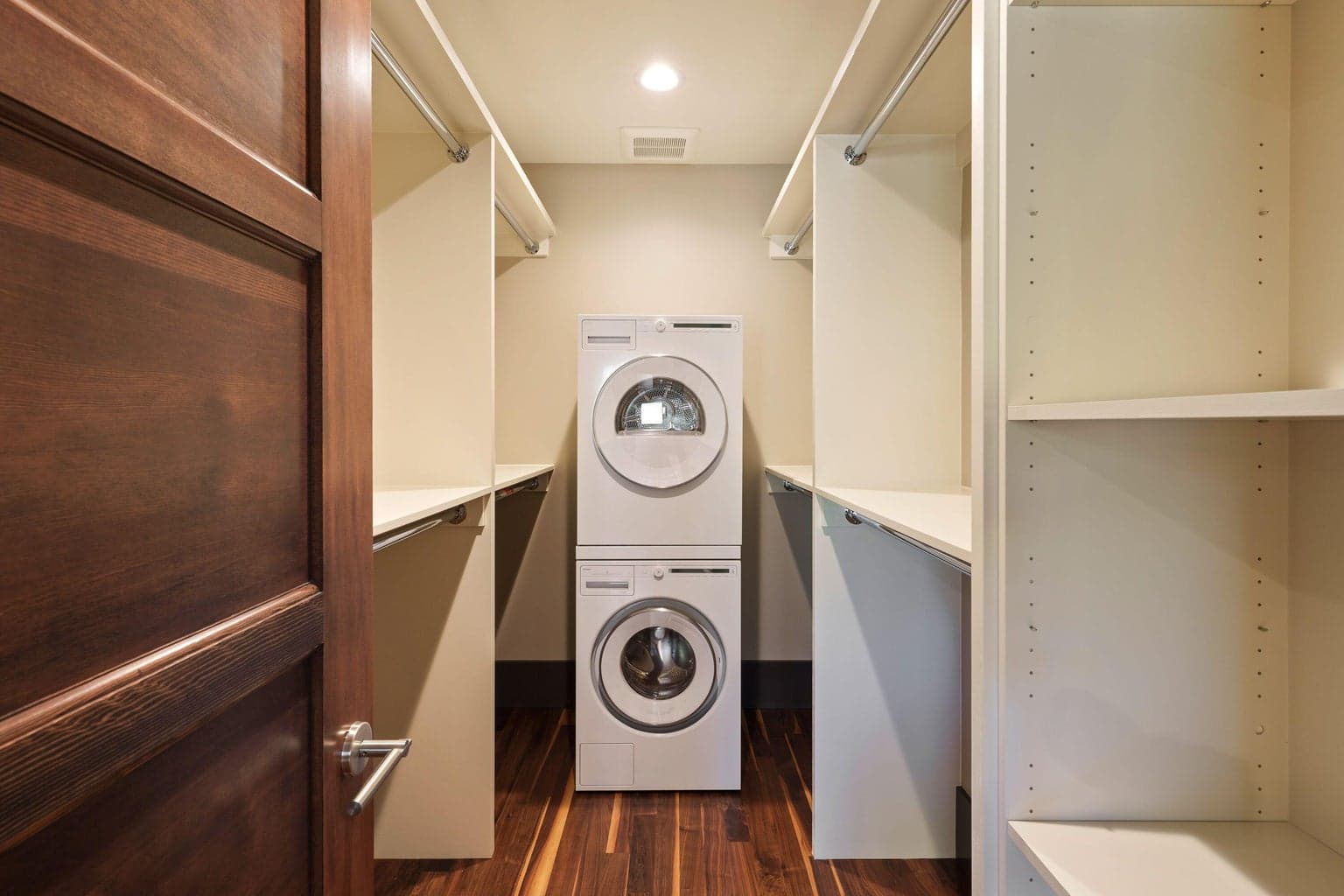 Third walk-in closet within the primary suite, complete with integrated laundry for added convenience.