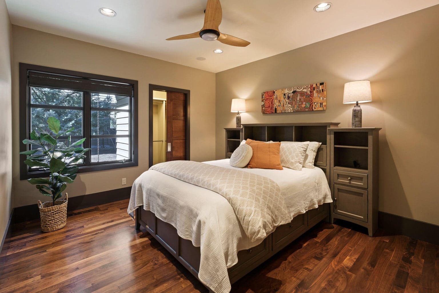 Comfortable guest suite with warm finishes and easy access to the home’s main living areas.