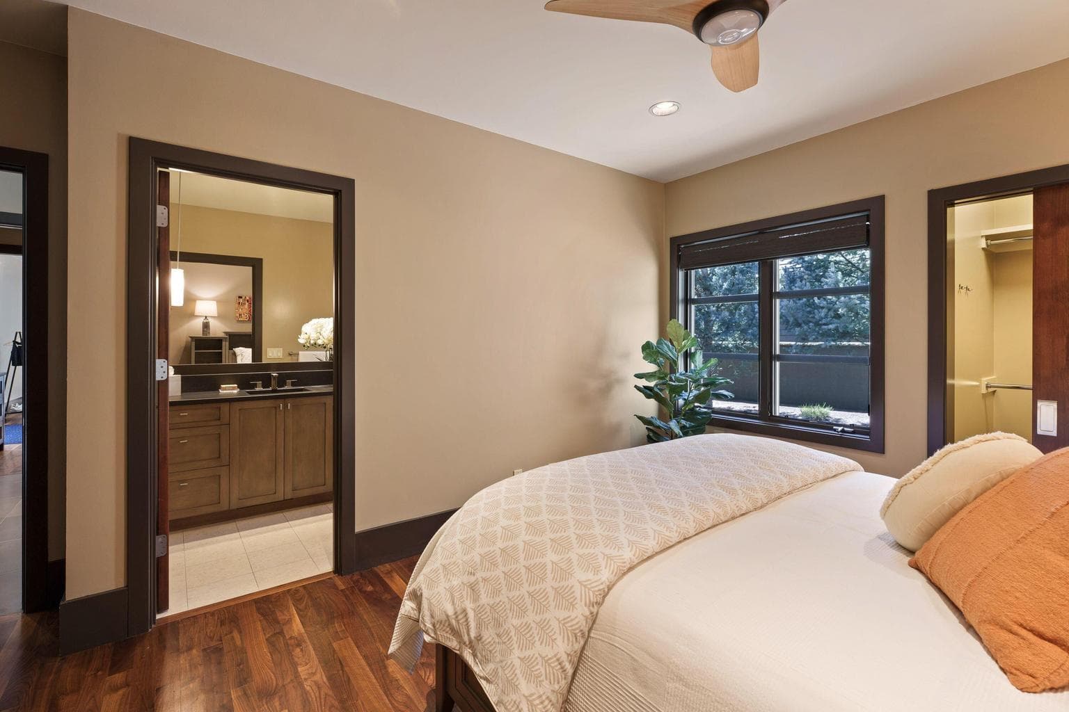 Guest suite with en-suite bath and walk-in closet, offering comfort and privacy for visitors.