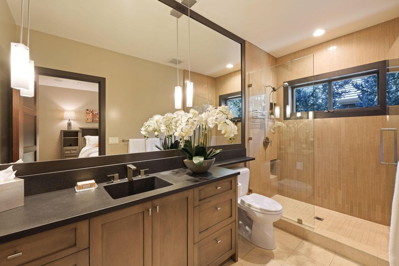 Guest bath with walk-in shower, modern finishes, and clean, functional design with concrete counters integrated sink.