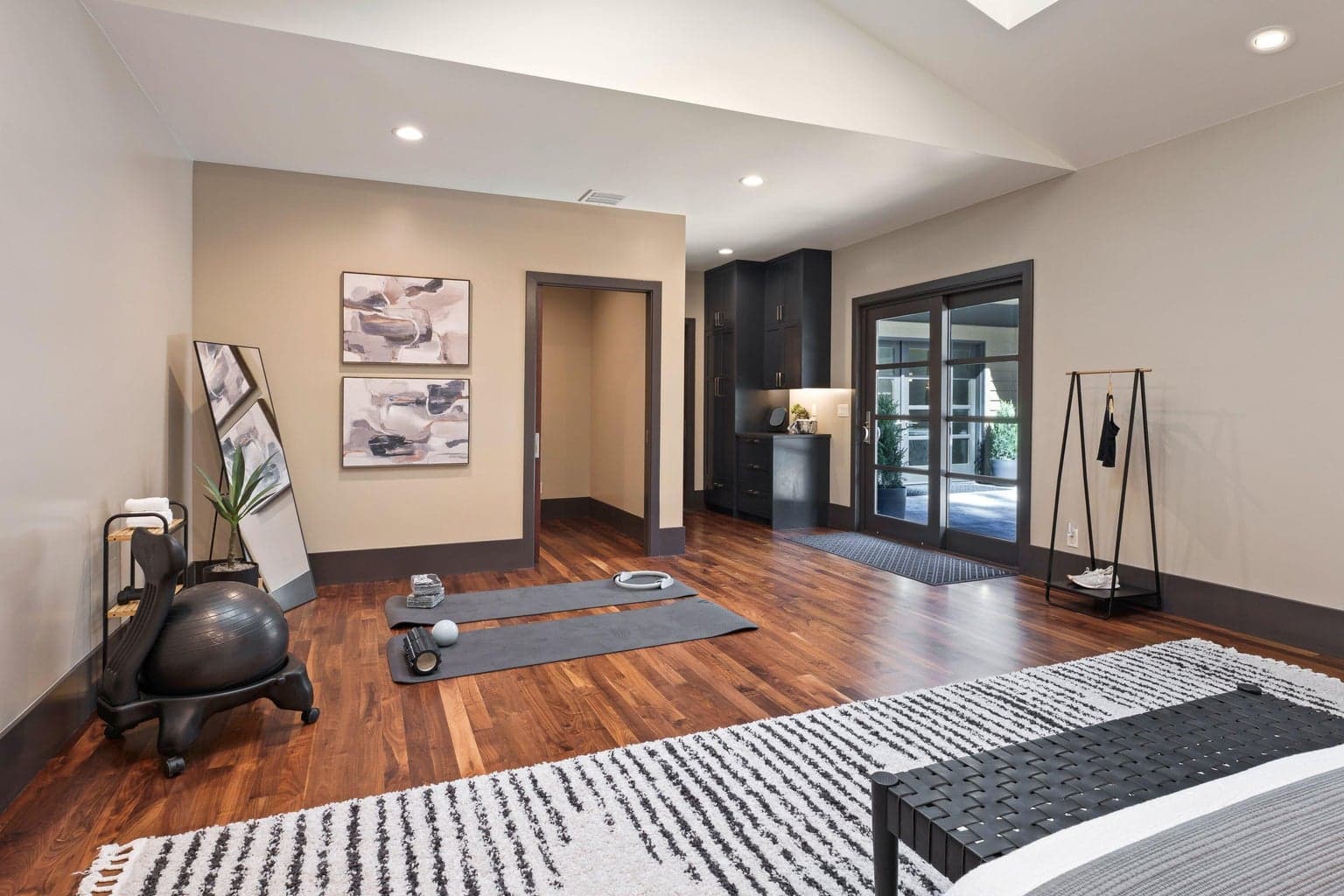 Spacious flex room and guest suite with vaulted ceilings, skylights, and direct access to the outdoor courtyard—ideal for guests, a home gym, or creative space.