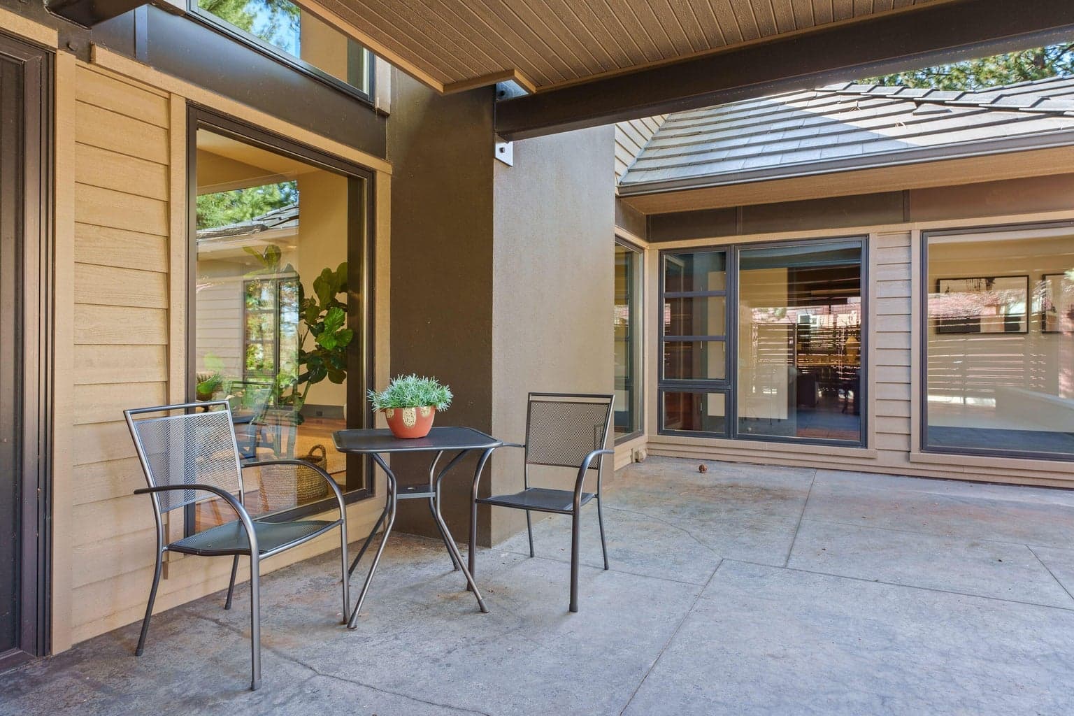 Additional courtyard seating area within the covered patio—perfect for a quiet coffee or conversation, just steps from the main outdoor living space.