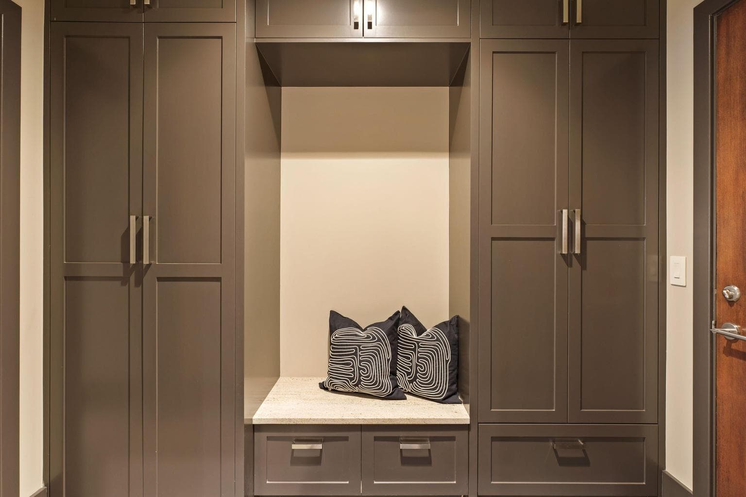 Custom drop zone just off the garage with built-in cabinetry, bench seating, and ample storage—perfect for keeping everyday life organized and out of sight.