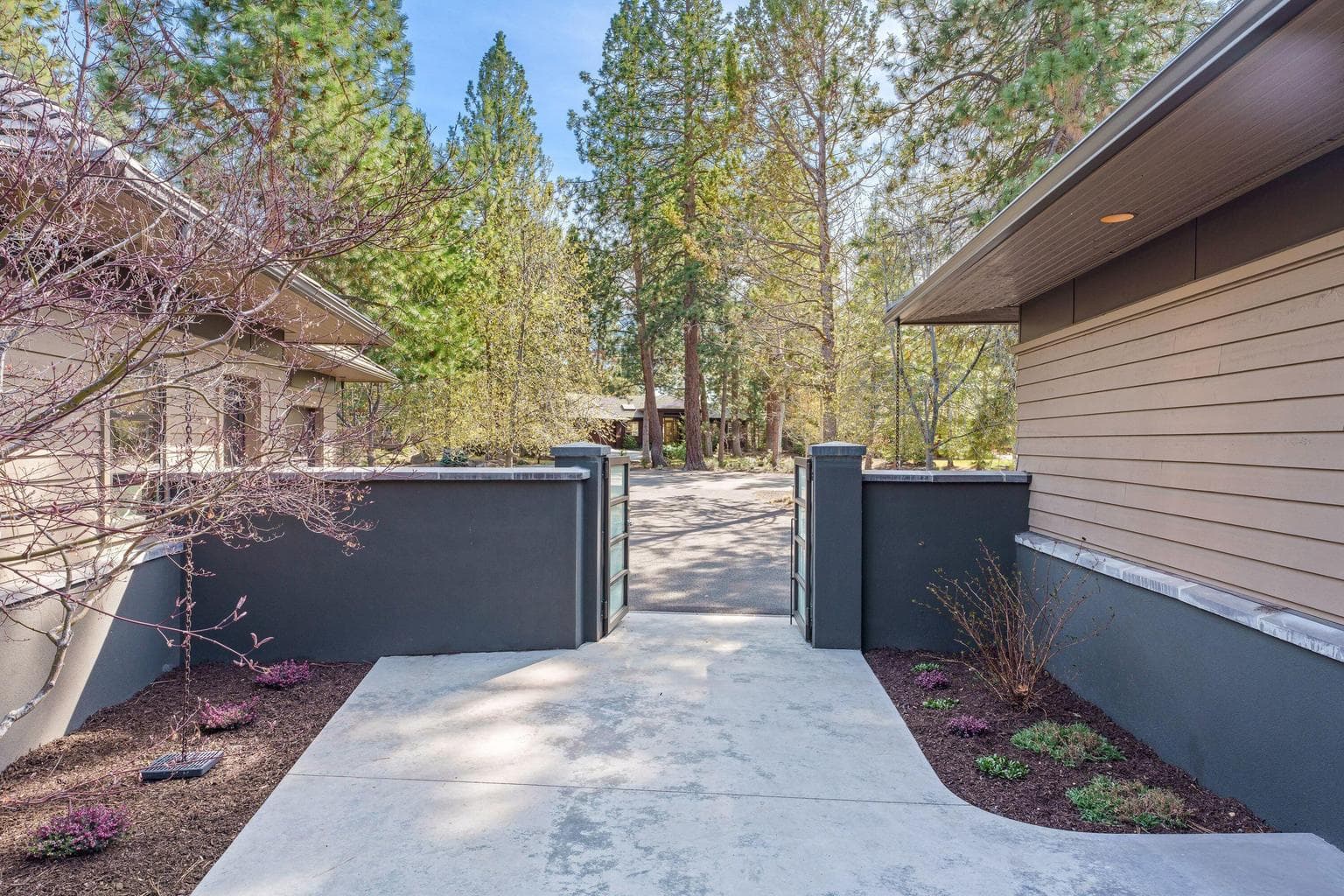 A gated courtyard entry adds an extra layer of privacy, with clean lines and low-maintenance landscaping creating a calm, welcoming transition from the outside in.