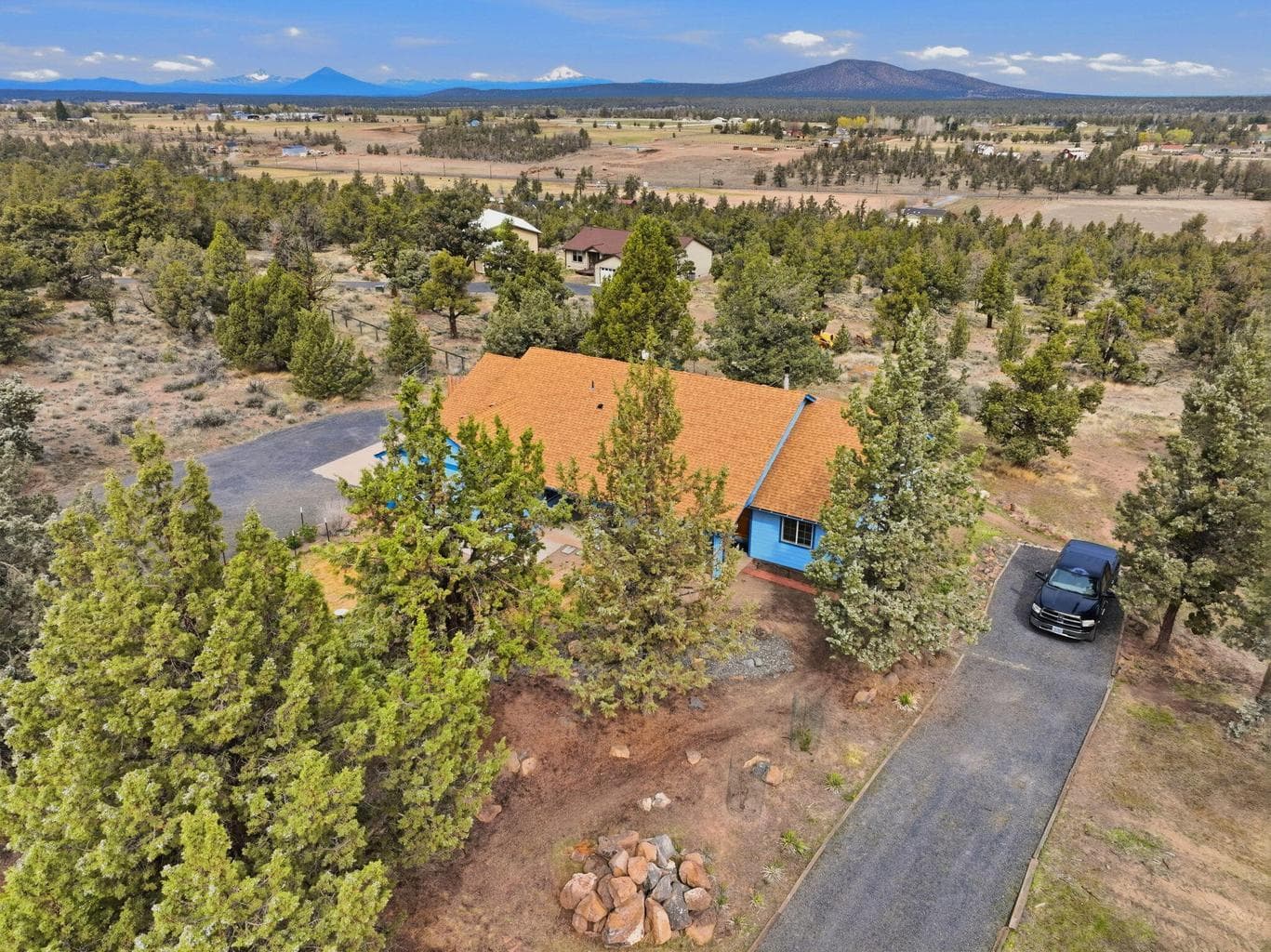 View of home looking towards back of property and second driveway entrance/RV parking.
