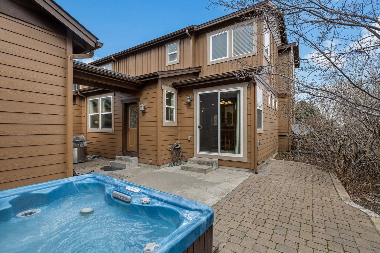Private fenced interior courtyard with paver patio and hot-tub.