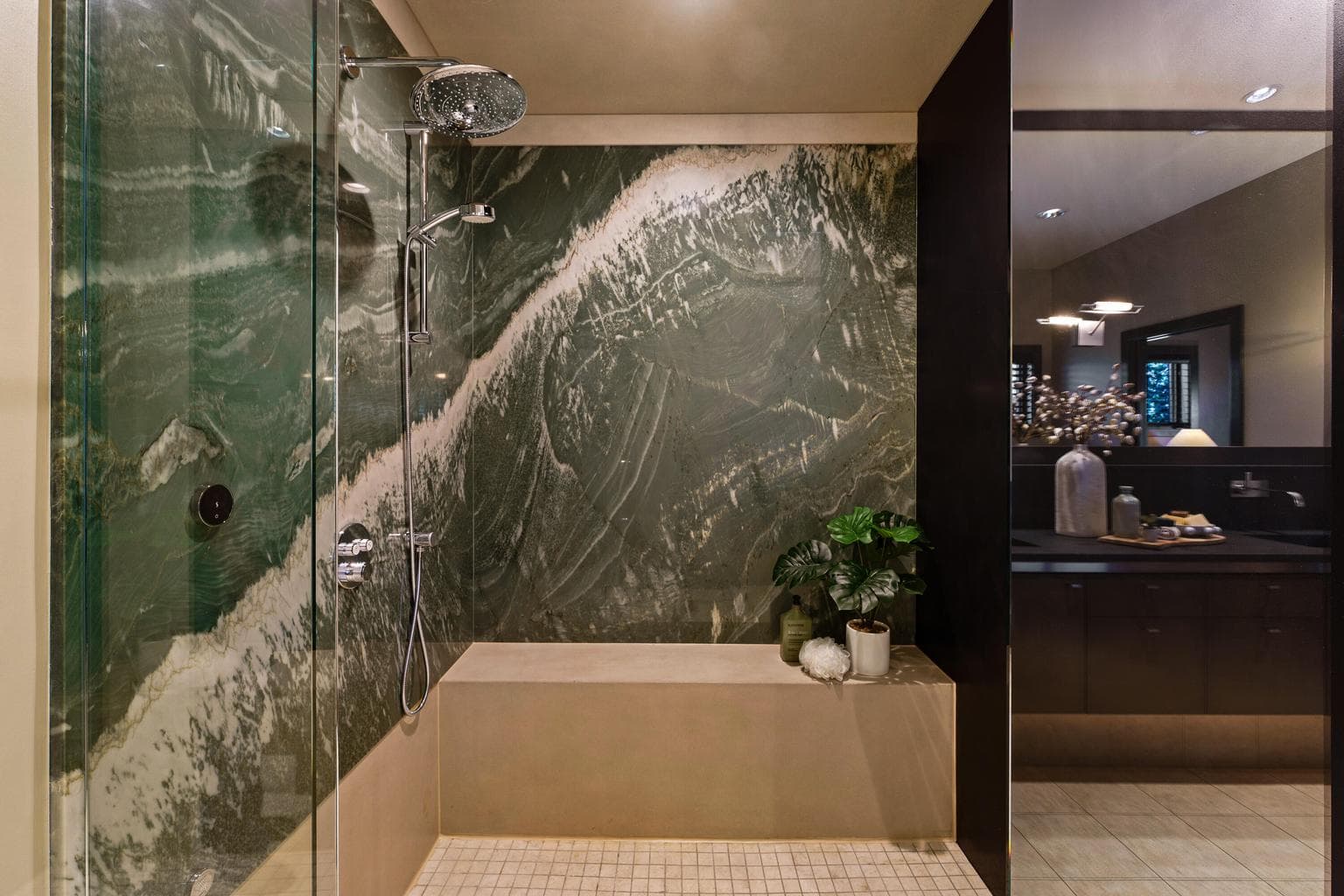 Steam shower with dramatic full slab stone walls and a custom concrete bench, creating a true spa-like retreat