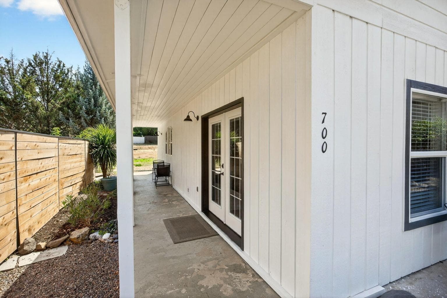 A covered porch runs the entire length of the home perfect for summer relaxation