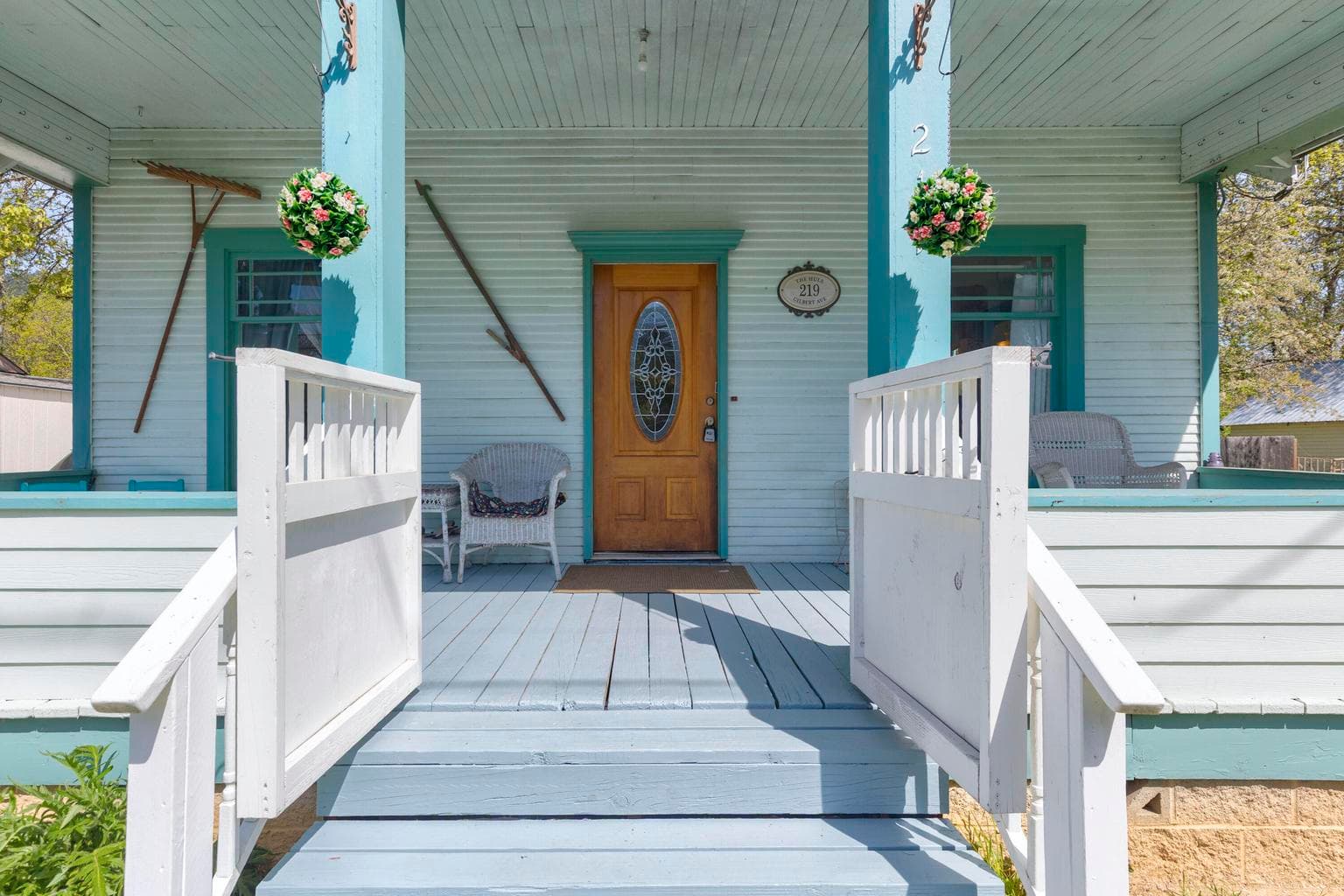 Charming covered front porch with gate.