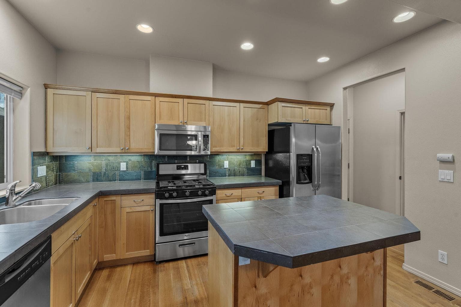 Kitchen view highlighting the abundant cabinetry and stainless steel appliances.