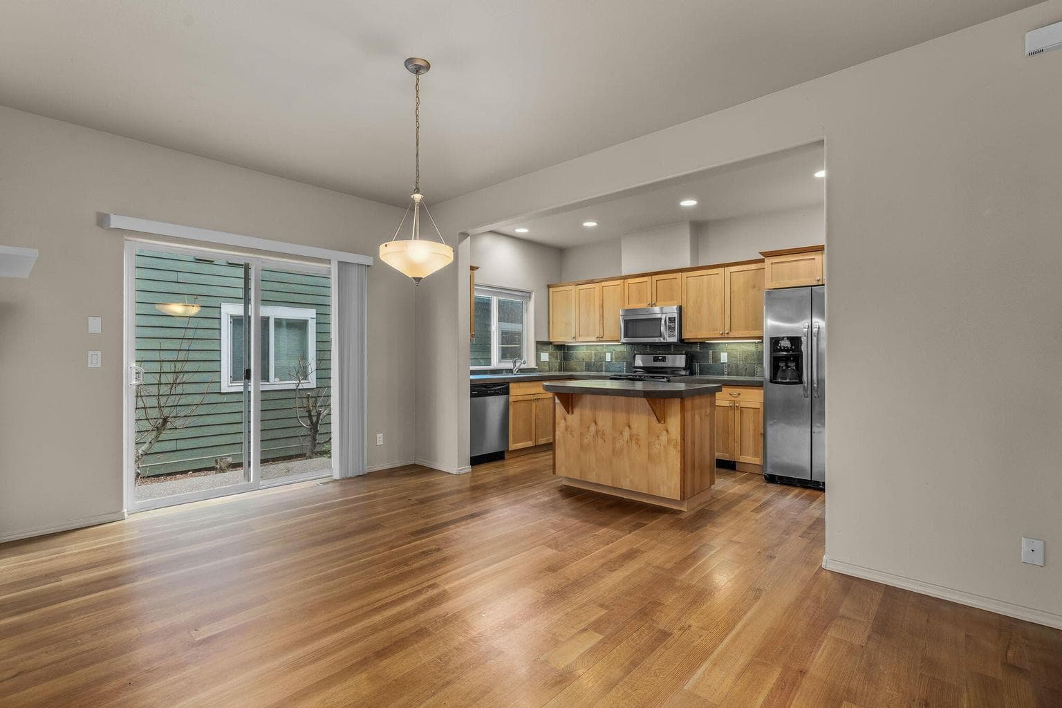Dining area with sliding glass doors leading to the side patio.